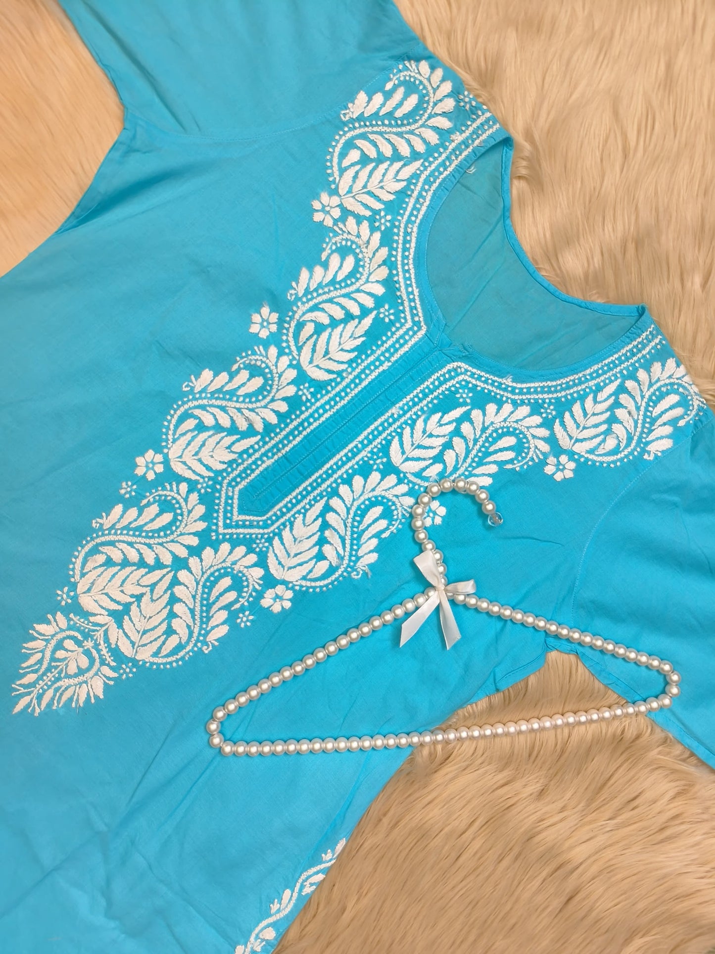 Turquoise blue cotton kurta with white Chikankari hand embroidery featuring paisley design, displayed with pearl hanger
