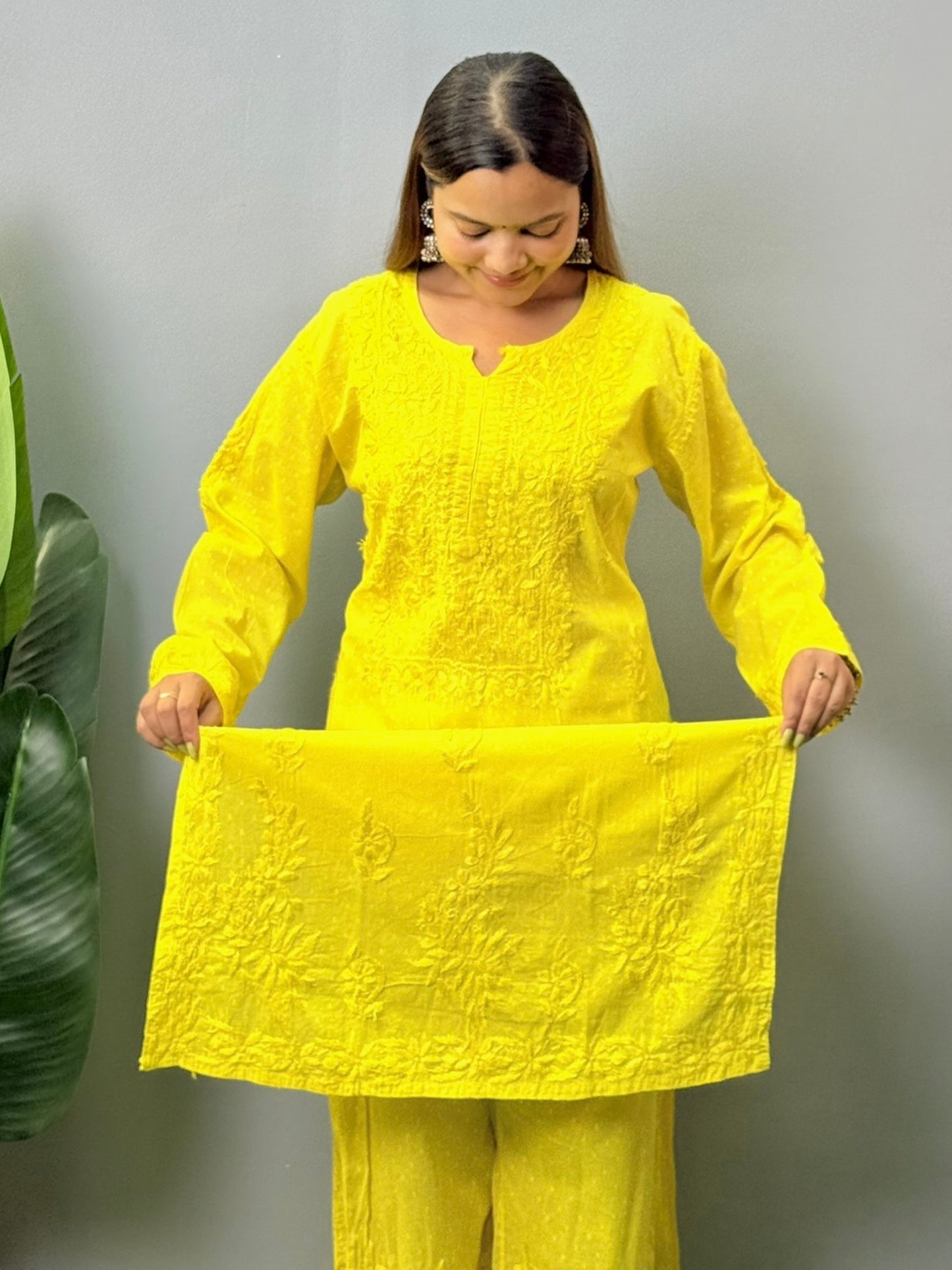 Model wearing bright yellow dobby cotton chikankari kurta and pant set