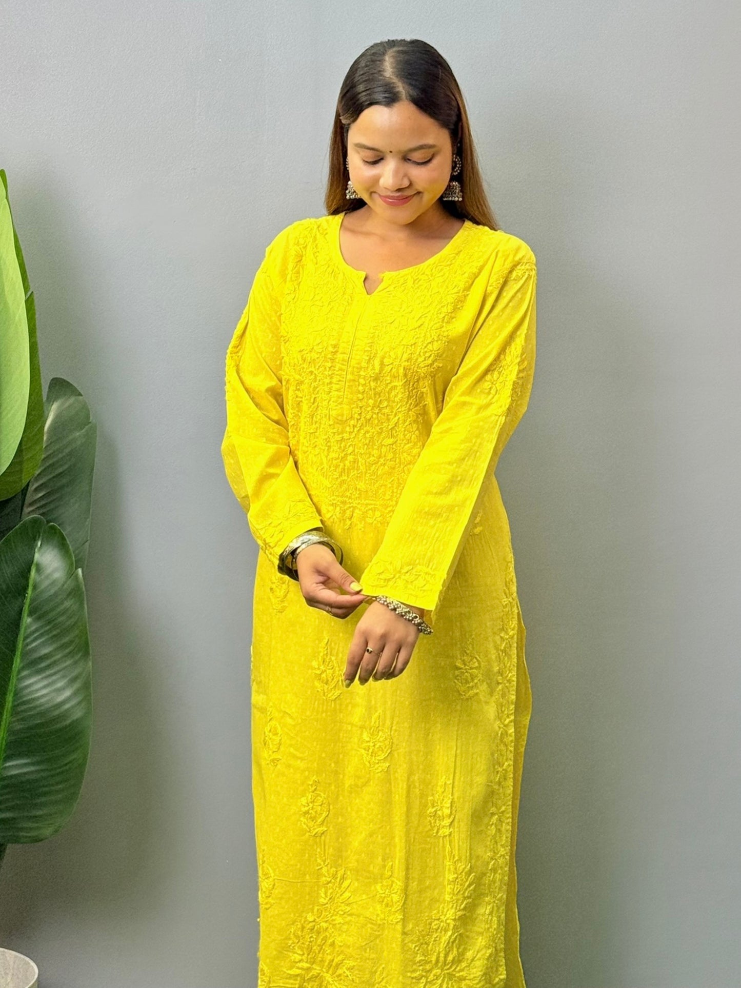 Model wearing bright yellow dobby cotton chikankari kurta and pant set