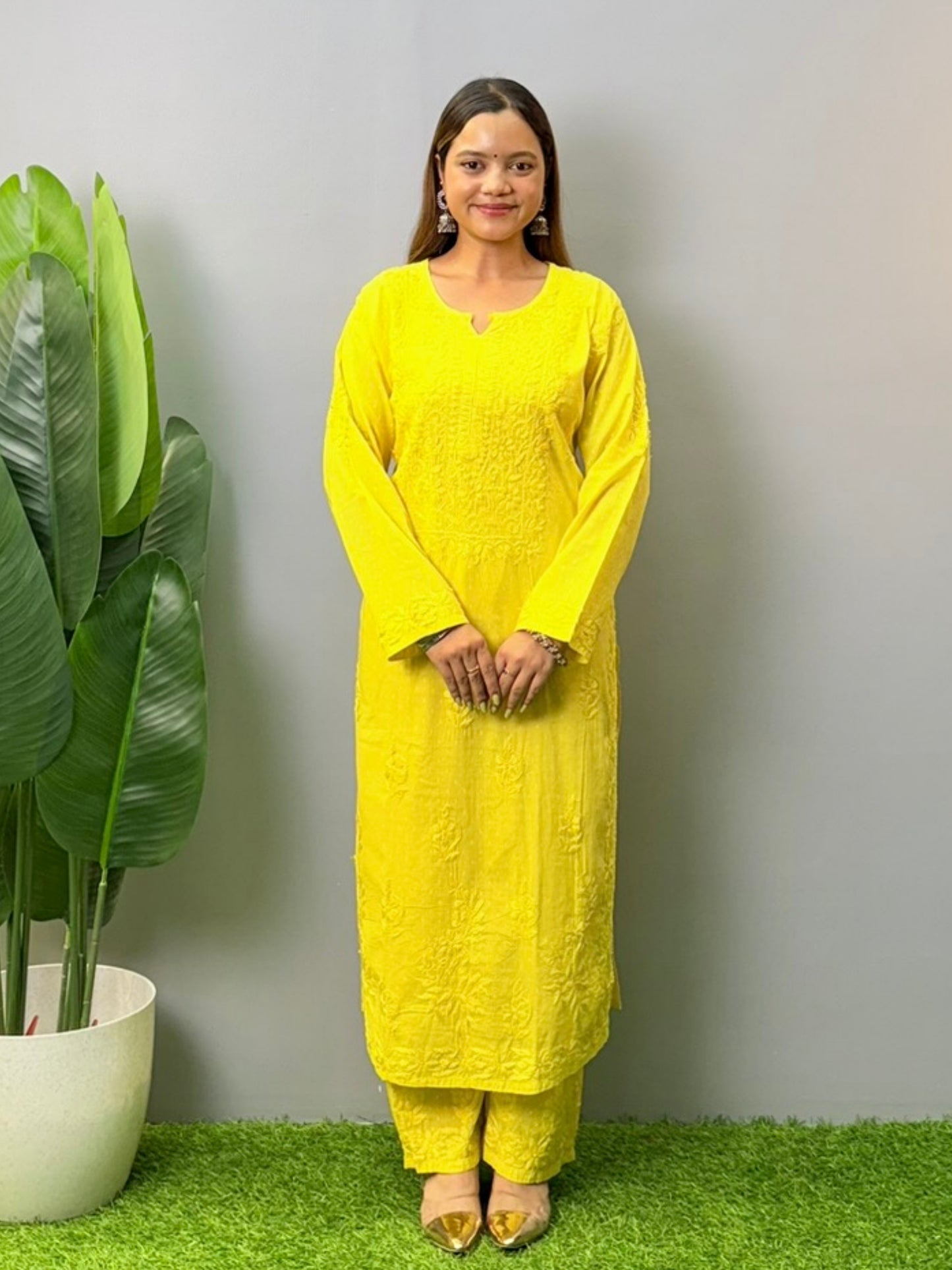 Model wearing bright yellow dobby cotton chikankari kurta and pant set