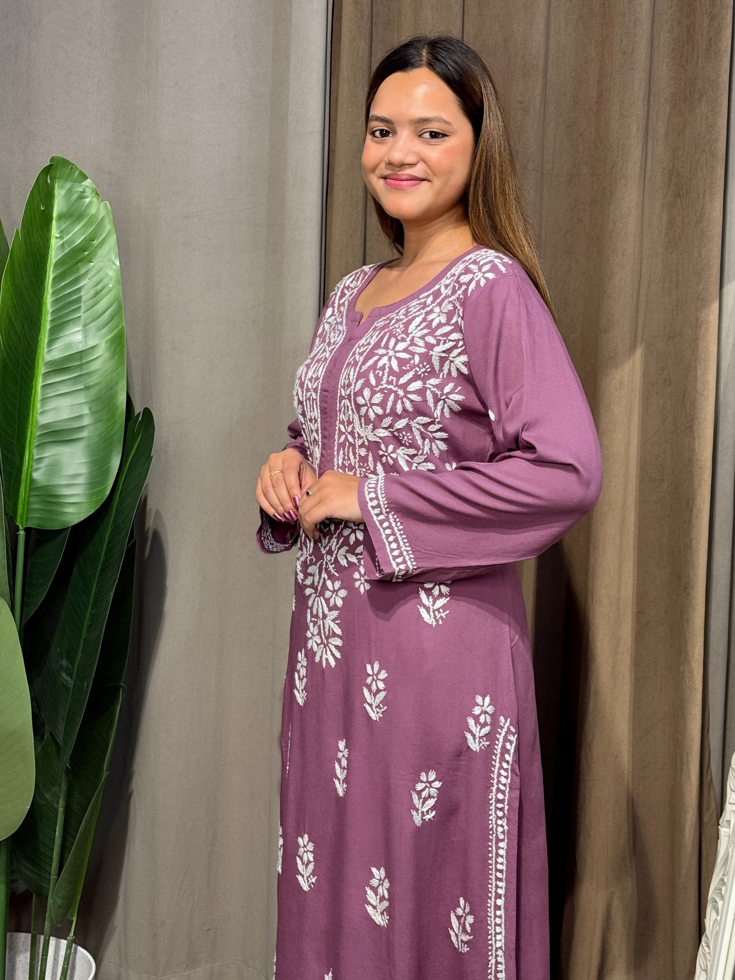Woman wearing a premium plum mauve rayon Lucknowi Chikankari straight cut kurta with white embroidery, full sleeves, by R S CHIKANKARI.