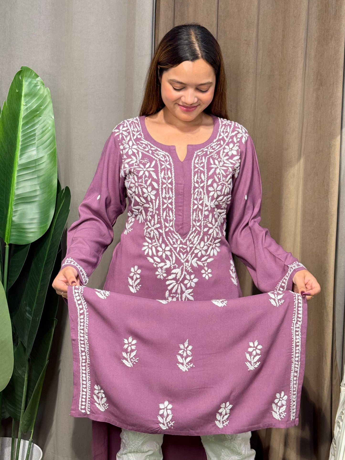 Woman wearing a premium plum mauve rayon Lucknowi Chikankari straight cut kurta with white embroidery, full sleeves, by R S CHIKANKARI.