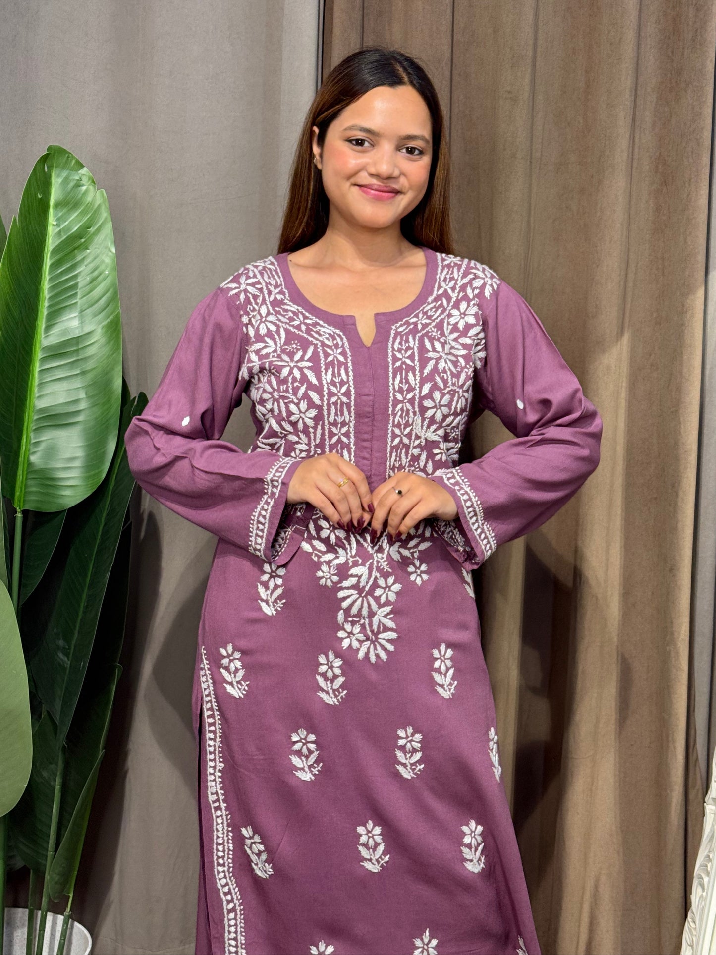 Woman wearing a premium plum mauve rayon Lucknowi Chikankari straight cut kurta with white embroidery, full sleeves, by R S CHIKANKARI.