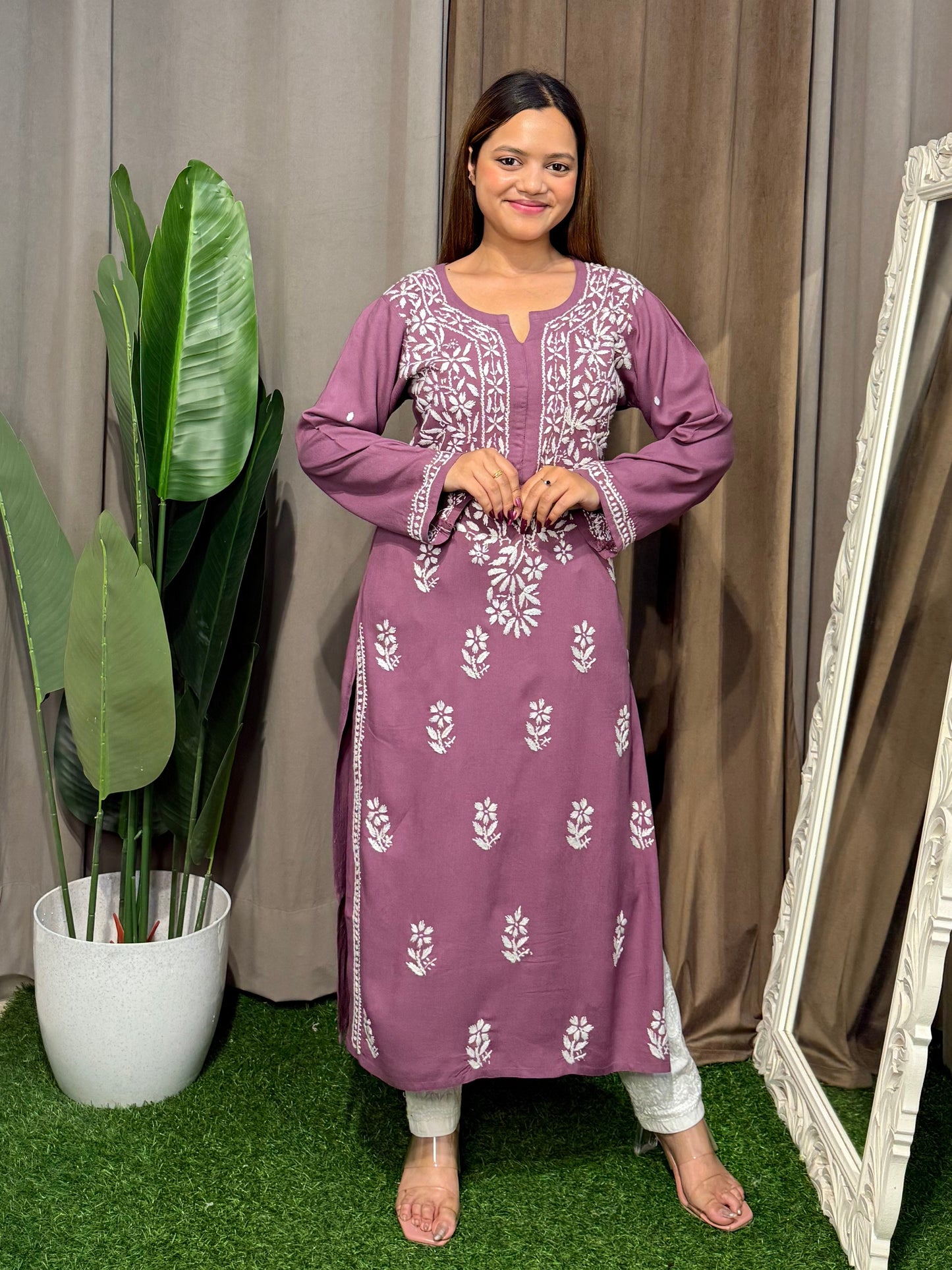 Woman wearing a premium plum mauve rayon Lucknowi Chikankari straight cut kurta with white embroidery, full sleeves, by R S CHIKANKARI.
