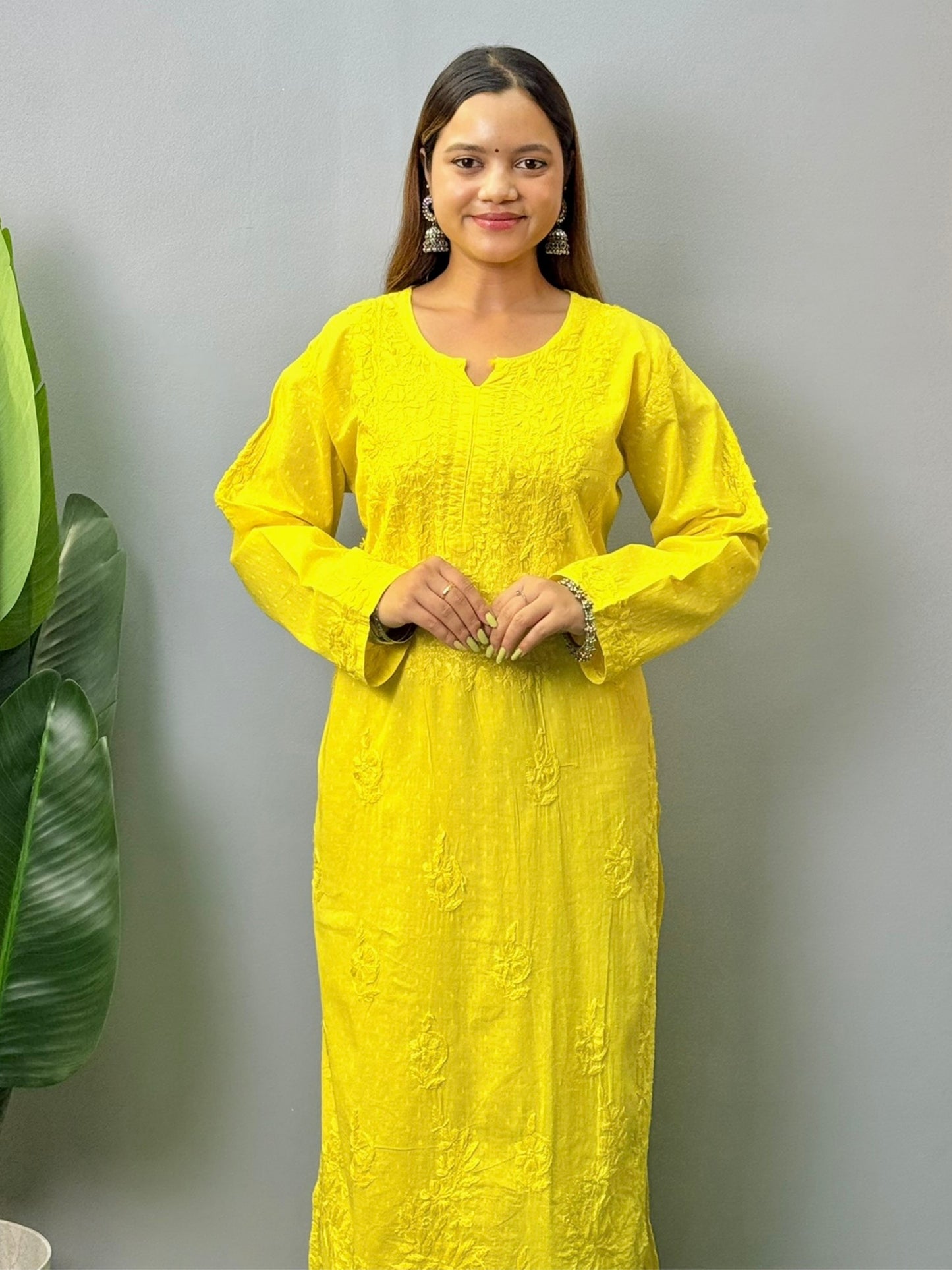 Model wearing bright yellow dobby cotton chikankari kurta and pant set