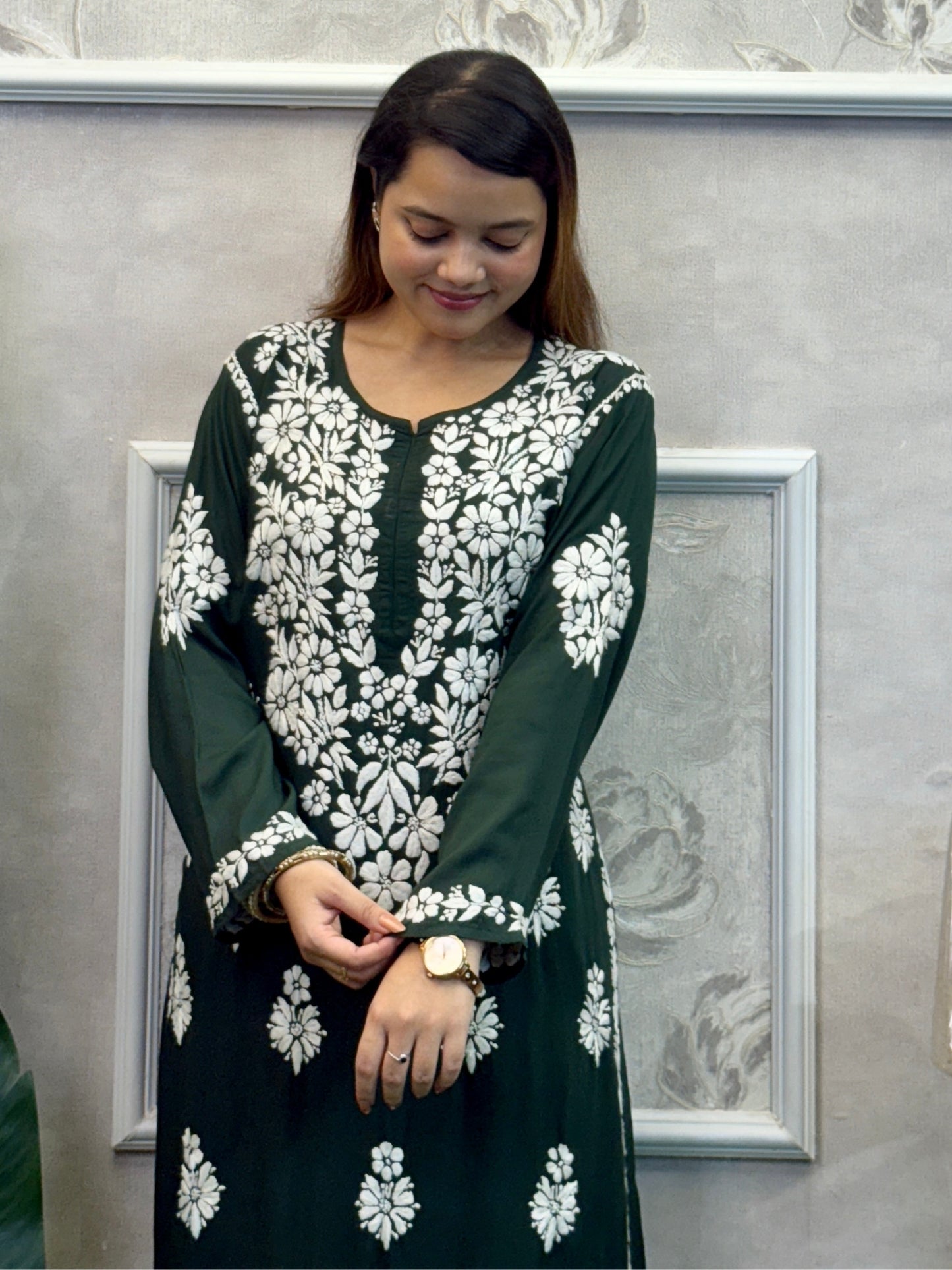 Dark green Lucknow Chikankari kurta and palazzo set in modal fabric with white hand embroidery.