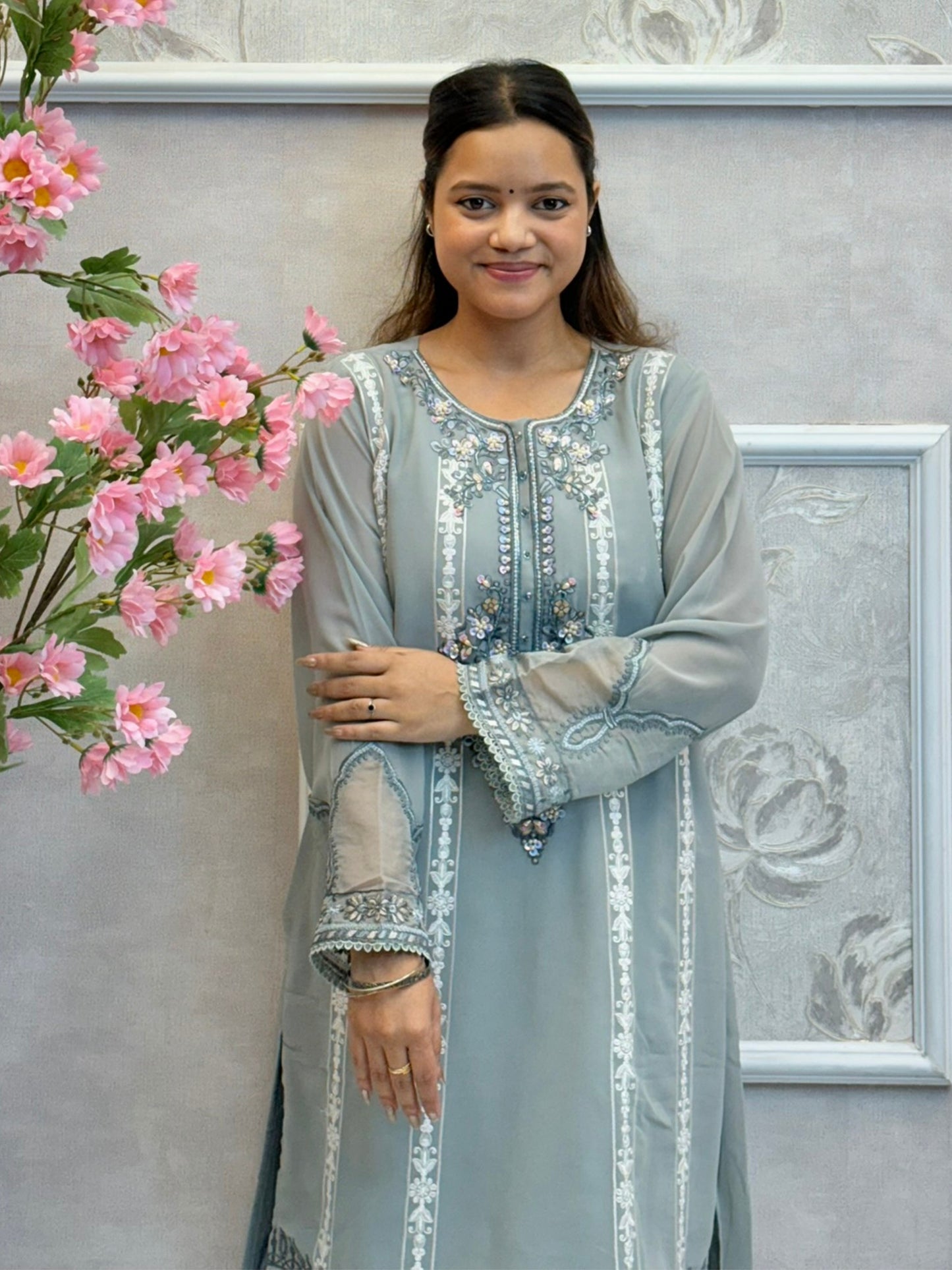Model wearing dusty blue chikankari designer suit with organza dupatta
