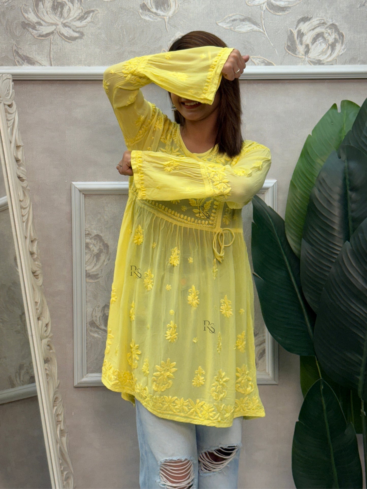 Yellow short angrakha style Lucknow Chikankari kurta in viscose fabric with hand embroidery.