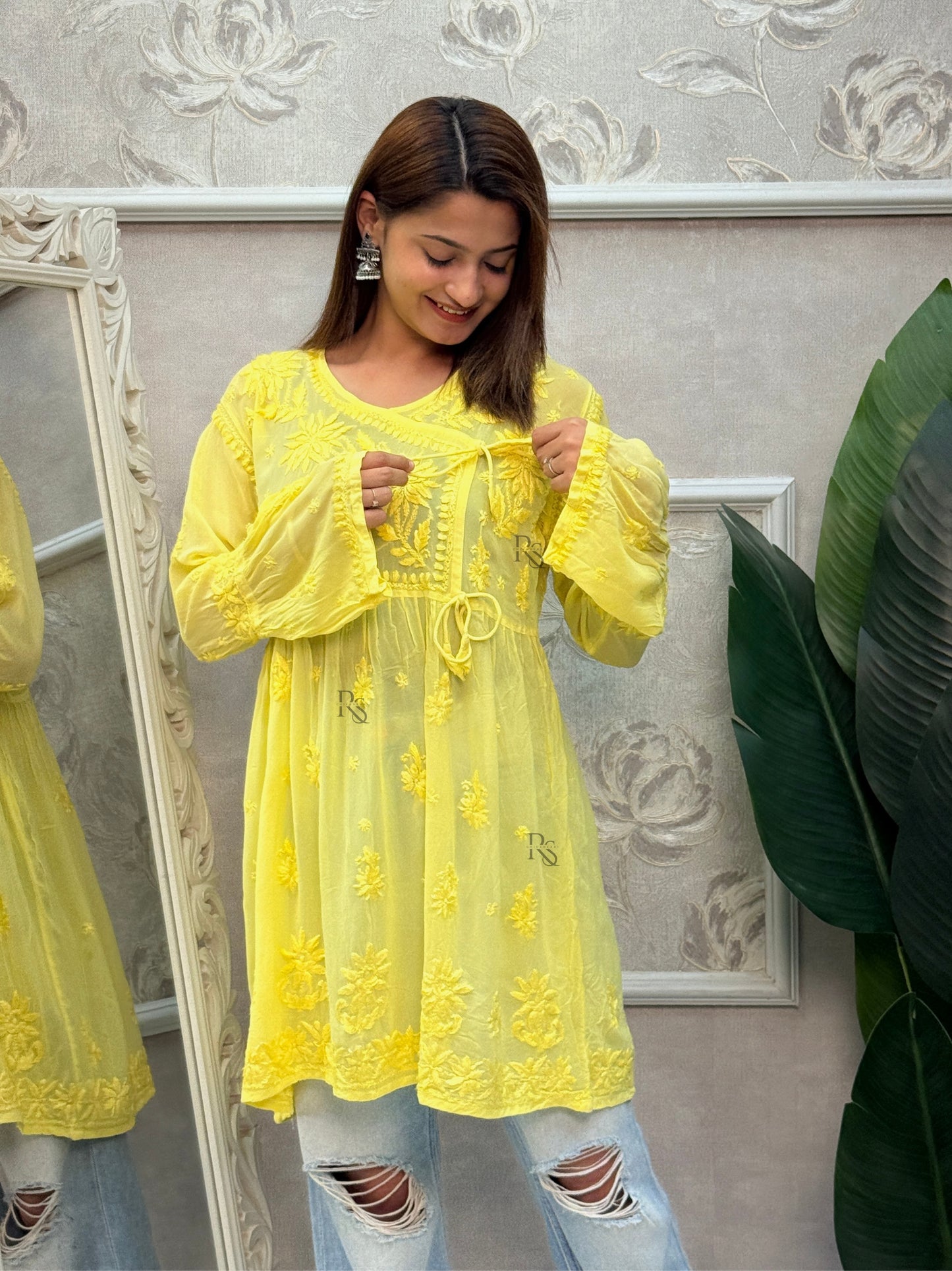 Yellow short angrakha style Lucknow Chikankari kurta in viscose fabric with hand embroidery.