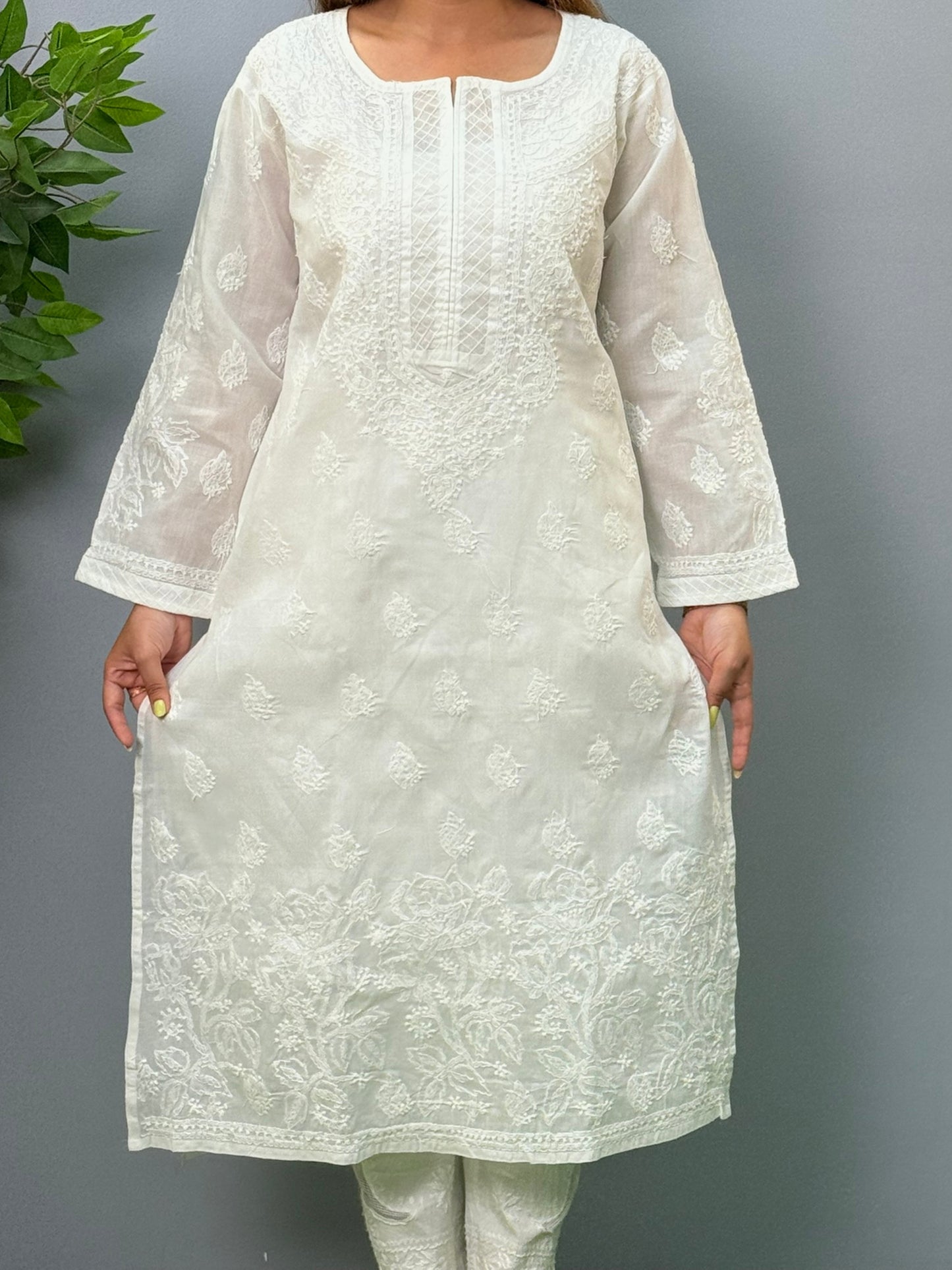 Model wearing a white voile cotton chikankari kurta with intricate hand embroidery