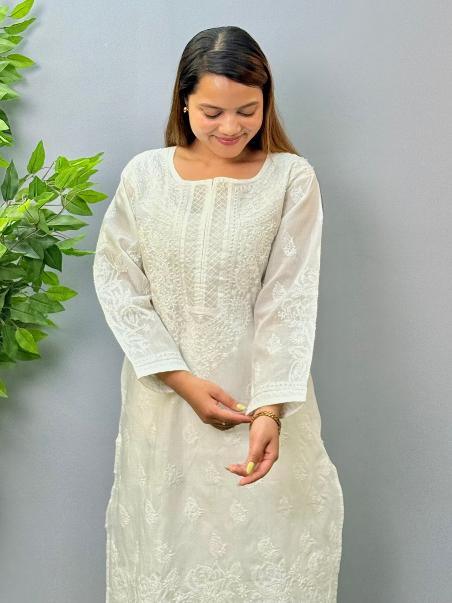 Model wearing a white voile cotton chikankari kurta with intricate hand embroidery