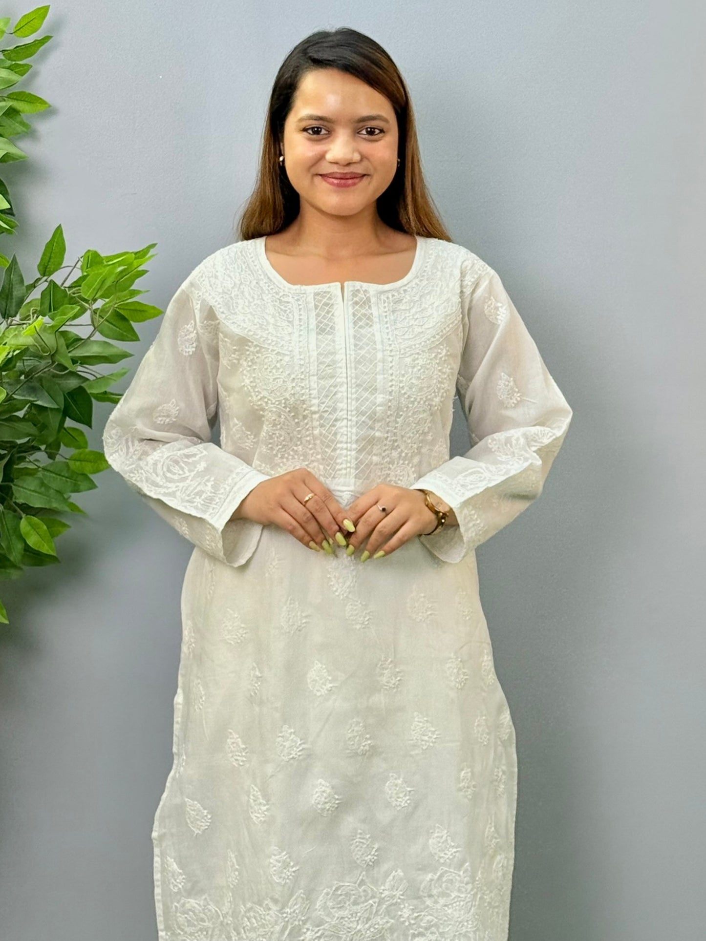 Model wearing a white voile cotton chikankari kurta with intricate hand embroidery