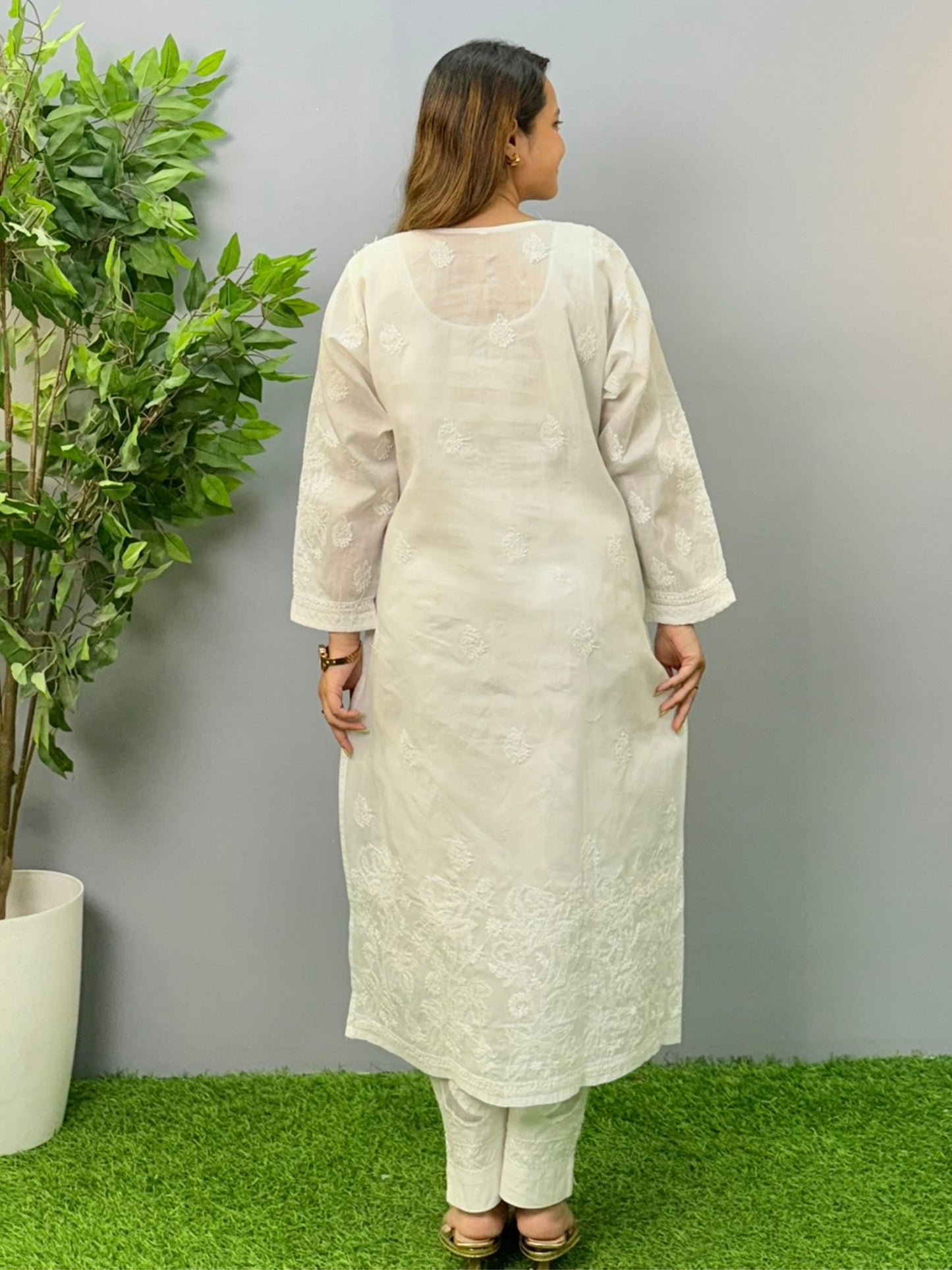 Model wearing a white voile cotton chikankari kurta with intricate hand embroidery