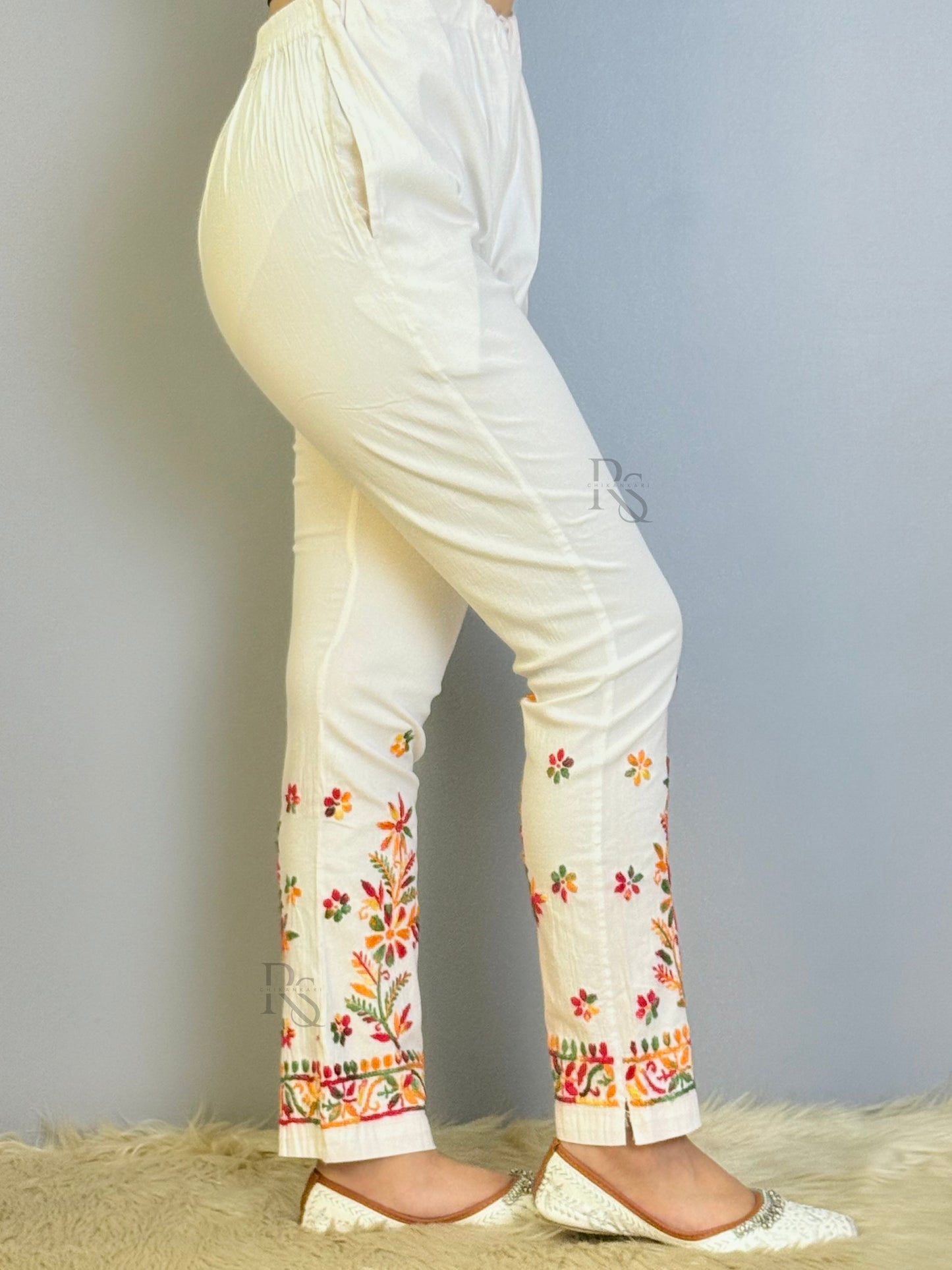 White chikankari cotton pant with multicolor floral embroidery and slit hem design