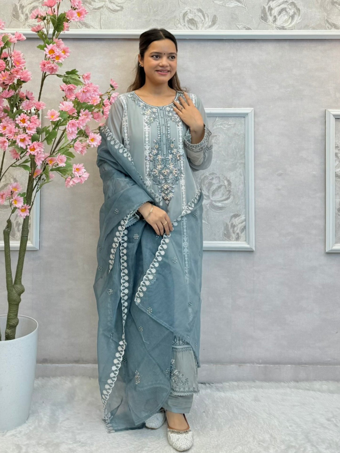 Model wearing dusty blue chikankari designer suit with organza dupatta
