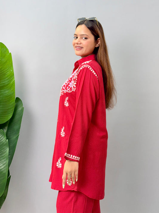 Model wearing a red rayon Lucknowi chikankari co-ord set featuring white hand embroidery on shirt-style kurta and matching pants.