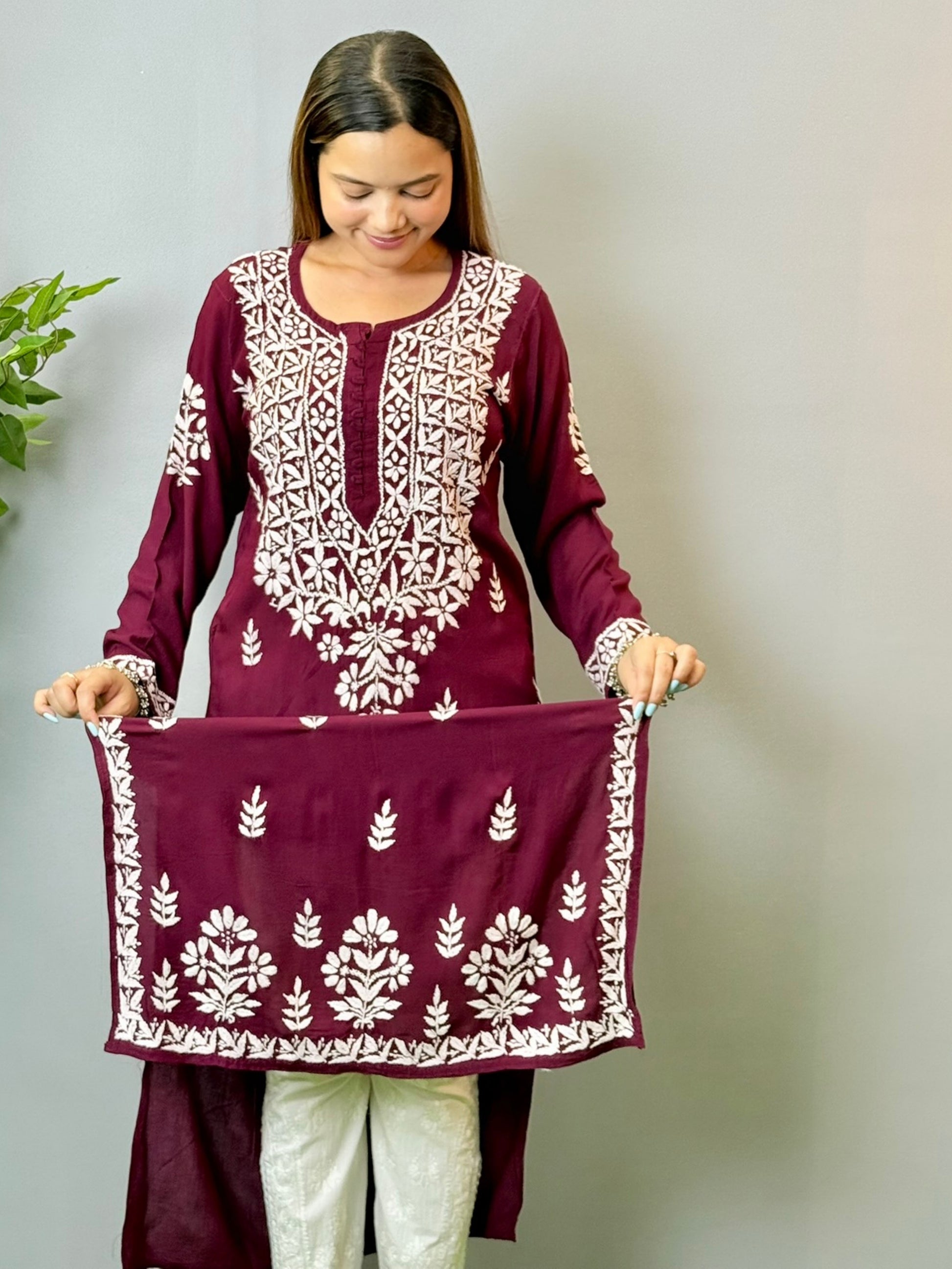 Model wearing a wine maroon Lucknowi chikankari kurta in soft modal fabric with detailed white embroidery work.