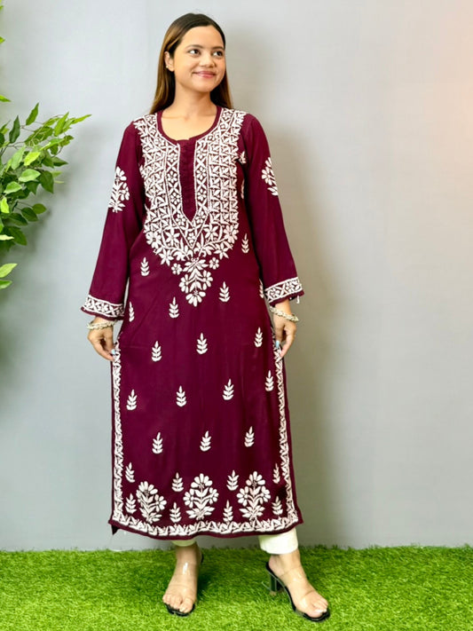 Model wearing a wine maroon Lucknowi chikankari kurta in soft modal fabric with detailed white embroidery work.