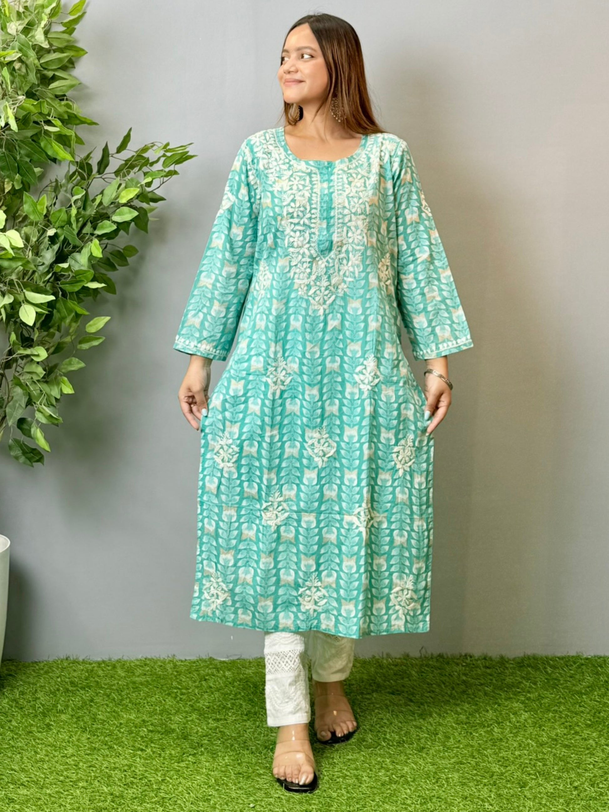 Model wearing an aqua blue printed chikankari mulmul kurta with white embroidery detailing