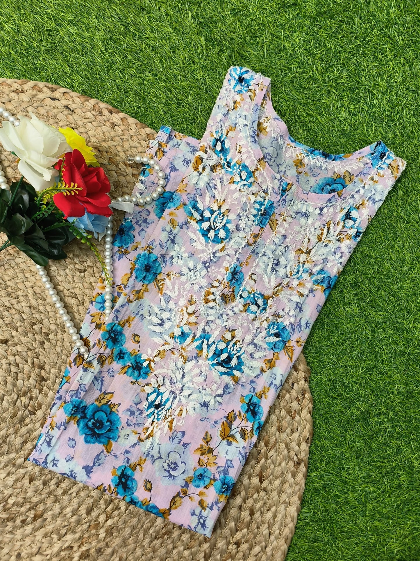 Flat lay of premium big size soft pink mulmul Lucknowi Chikankari kurta with vibrant blue floral print and white embroidery, by R S CHIKANKARI.
