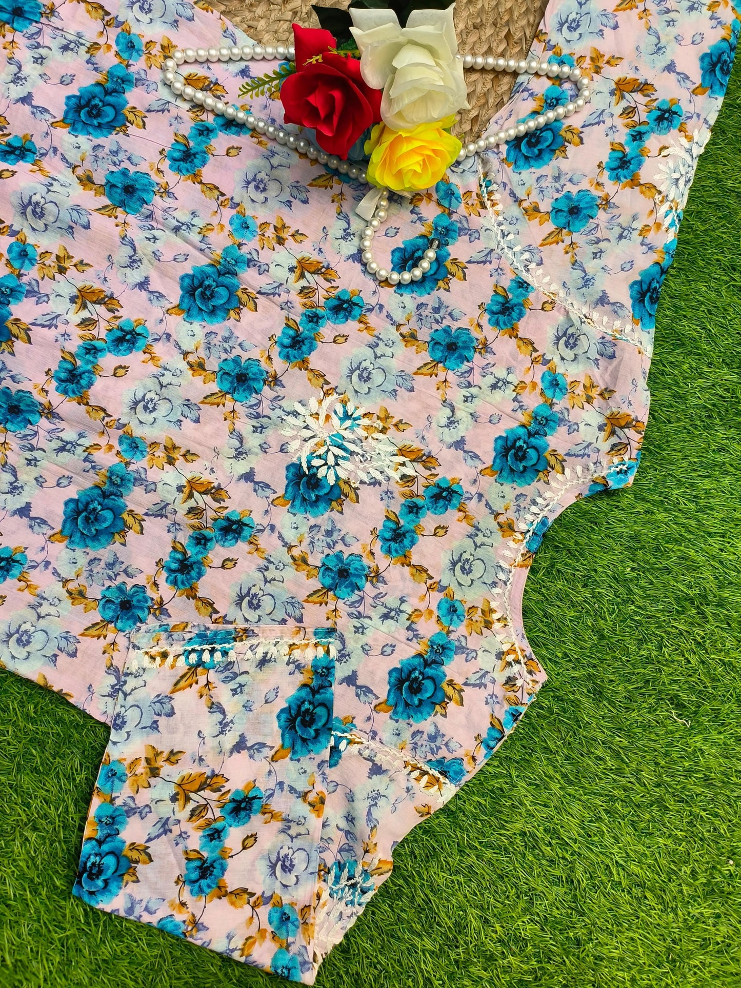 Flat lay of premium big size soft pink mulmul Lucknowi Chikankari kurta with vibrant blue floral print and white embroidery, by R S CHIKANKARI.