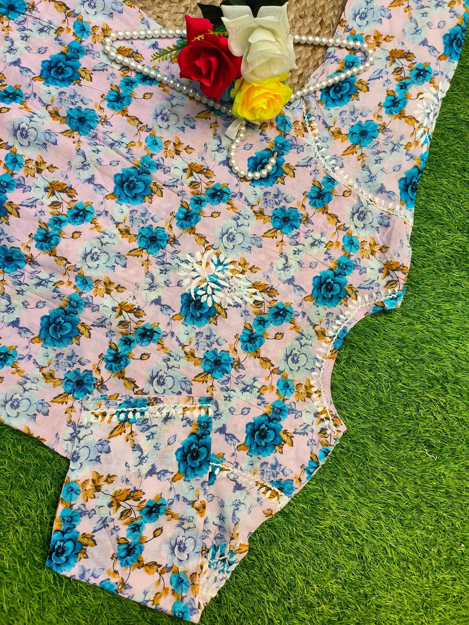 Flat lay of premium big size soft pink mulmul Lucknowi Chikankari kurta with vibrant blue floral print and white embroidery, by R S CHIKANKARI.