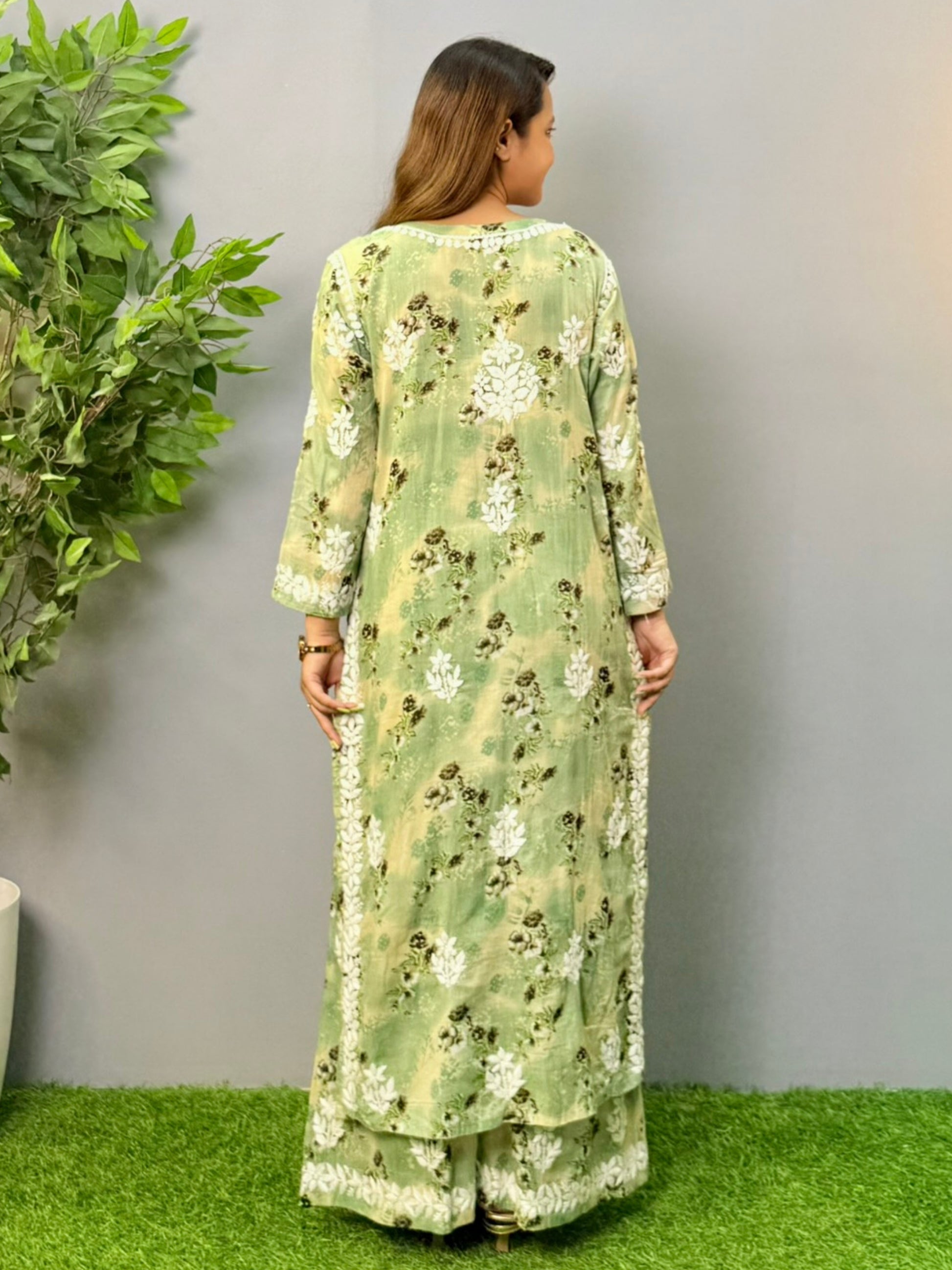 Model wearing olive floral printed mulmul chikankari kurta and palazzo set with white hand embroidery