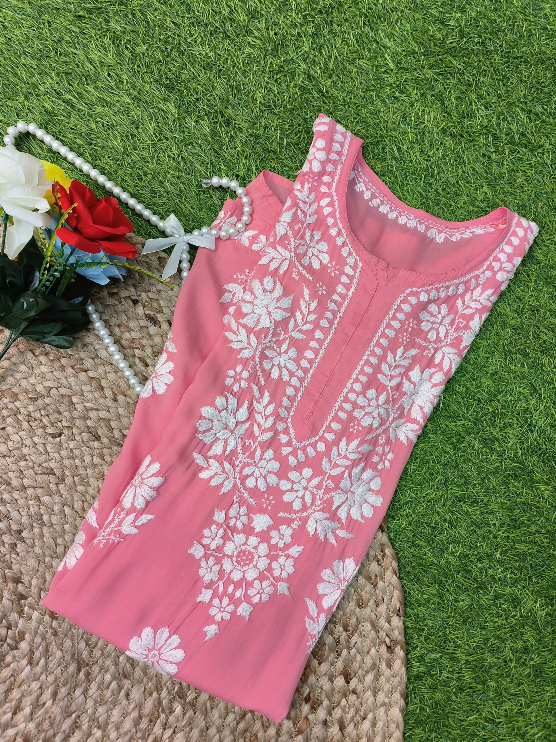 Flat lay of soft premium coral pink modal Lucknowi Chikankari kurta with white floral embroidery, by R S CHIKANKARI.