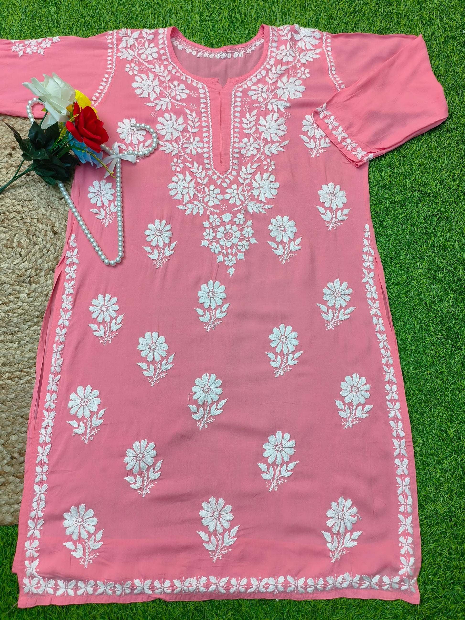 Flat lay of soft premium coral pink modal Lucknowi Chikankari kurta with white floral embroidery, by R S CHIKANKARI.