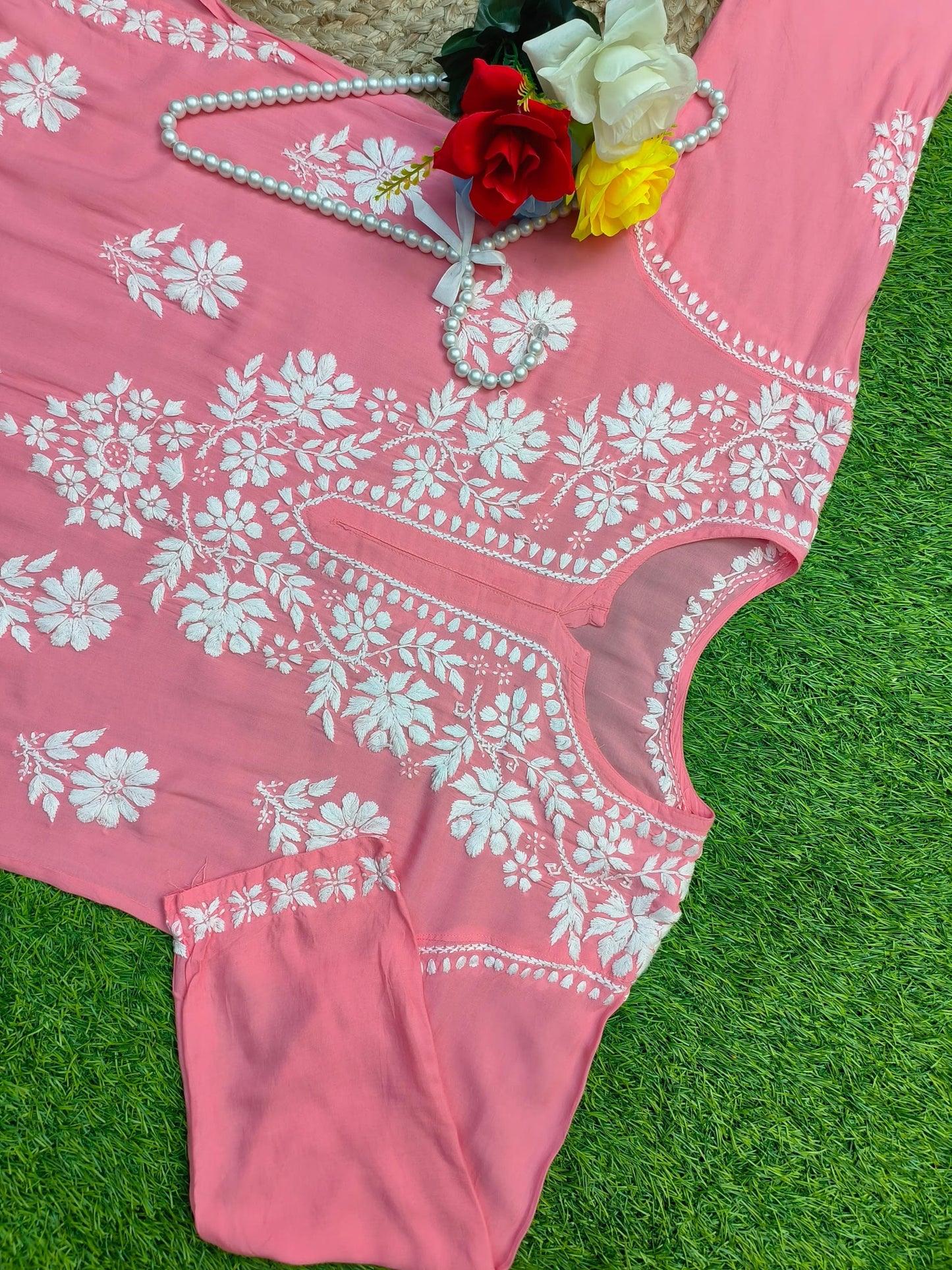 Flat lay of soft premium coral pink modal Lucknowi Chikankari kurta with white floral embroidery, by R S CHIKANKARI.