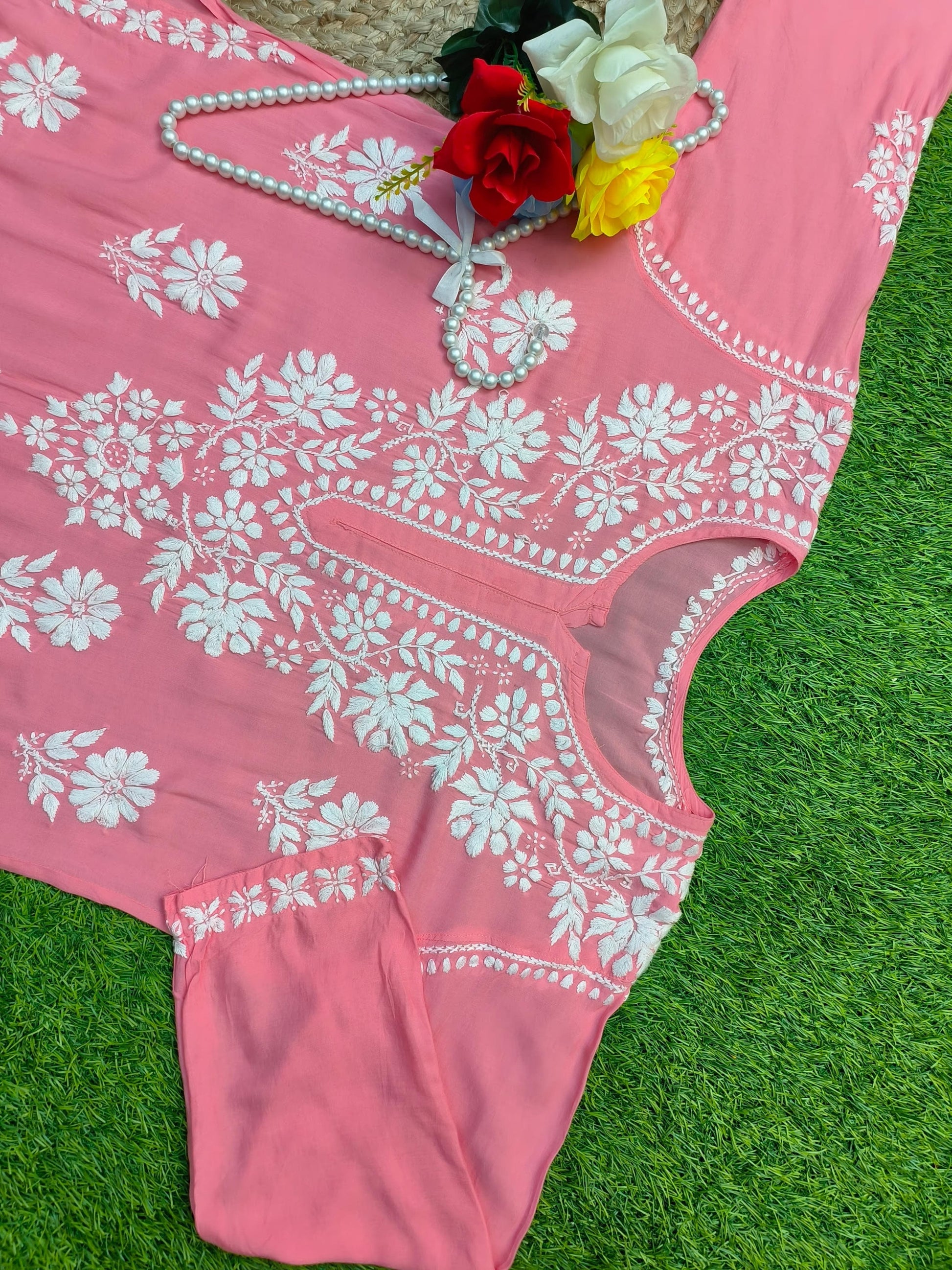 Flat lay of soft premium coral pink modal Lucknowi Chikankari kurta with white floral embroidery, by R S CHIKANKARI.