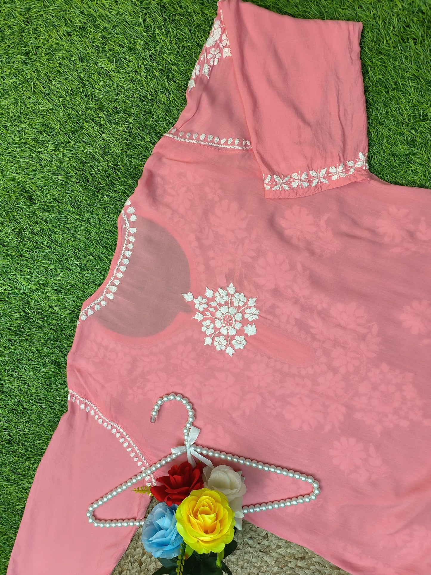 Flat lay of soft premium coral pink modal Lucknowi Chikankari kurta with white floral embroidery, by R S CHIKANKARI.