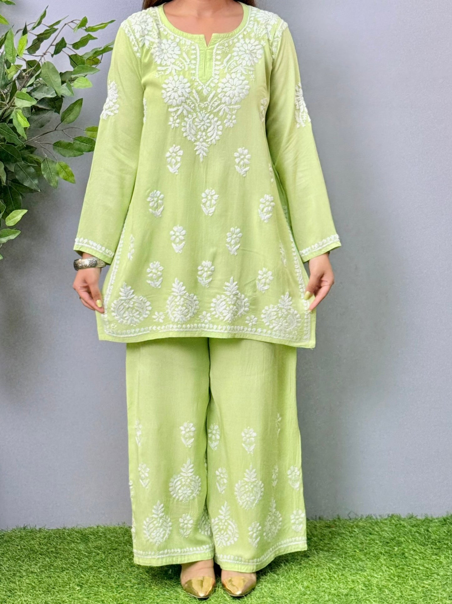 Model wearing pista green rayon short Chikankari kurta and palazzo set with white embroidery