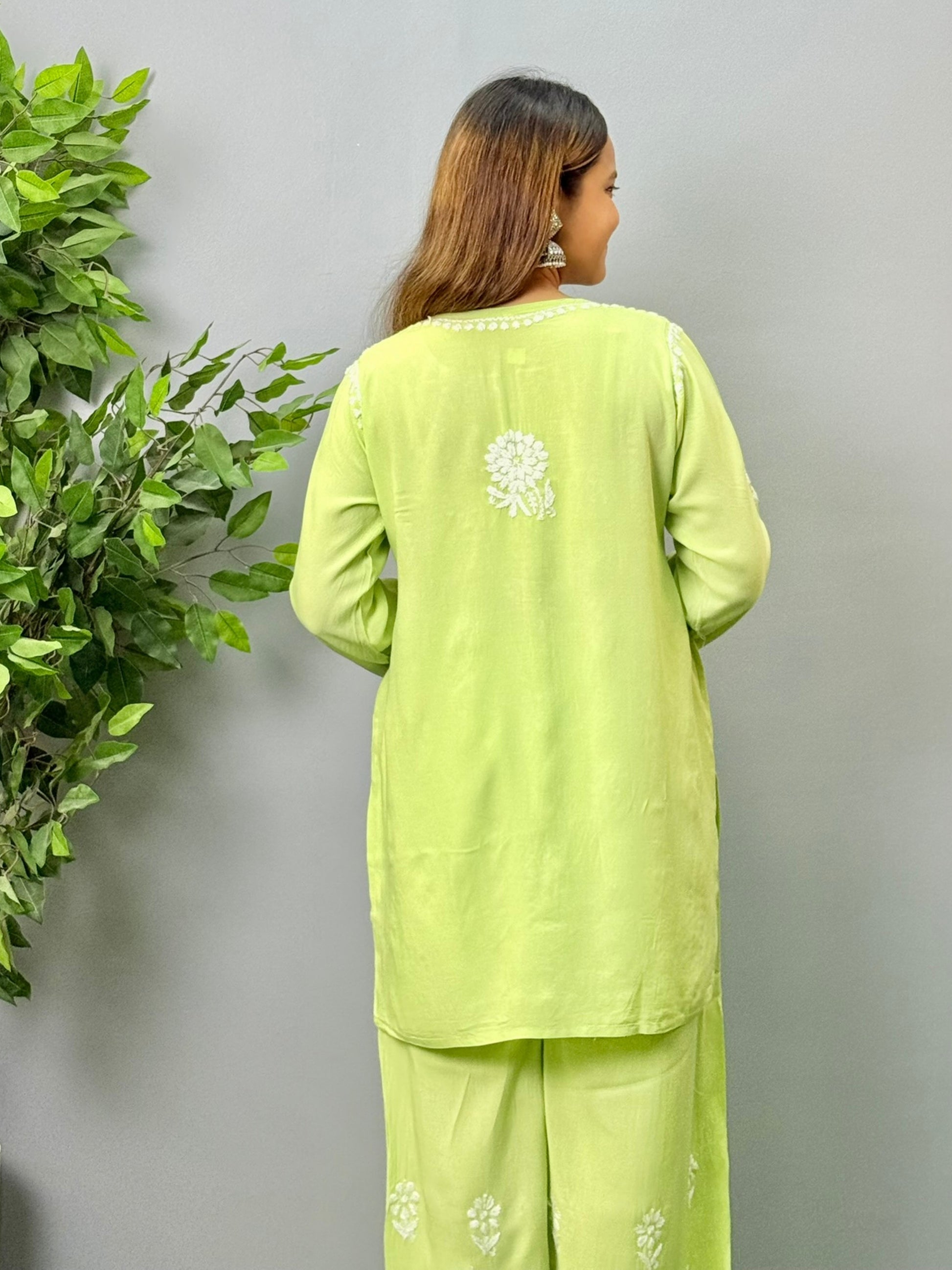 Model wearing pista green rayon short Chikankari kurta and palazzo set with white embroidery