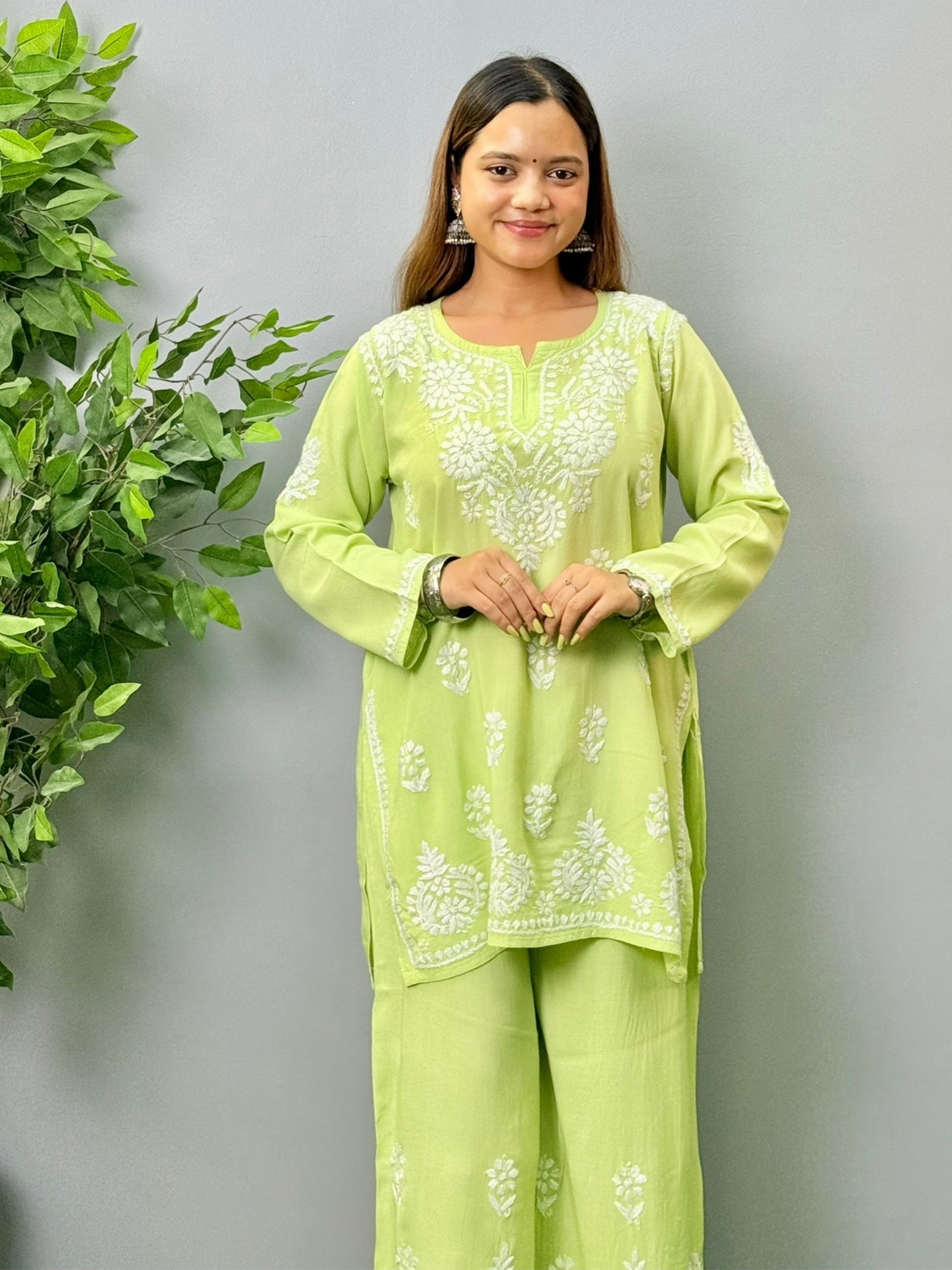 Model wearing pista green rayon short Chikankari kurta and palazzo set with white embroidery