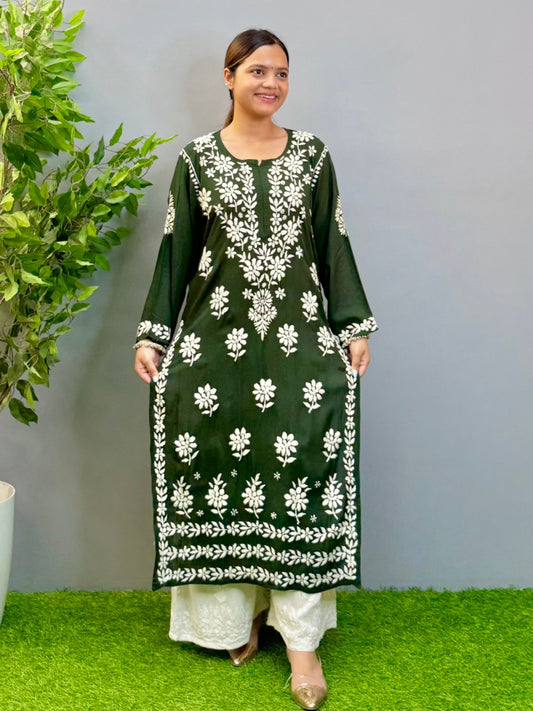 Model wearing a deep forest green modal Lucknowi chikankari kurta with rich white hand embroidery, styled with white palazzos.