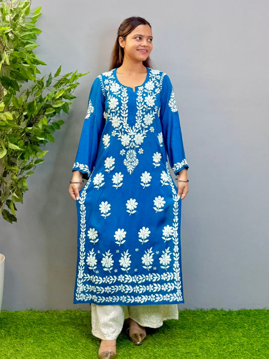 Woman wearing teal blue Chikankari kurta with white embroidery on modal fabric.