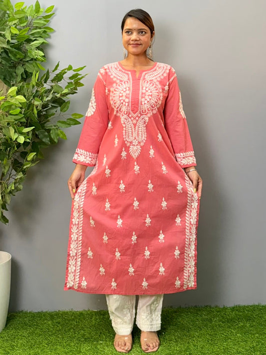 Model wearing a peach cotton chikankari kurta with detailed white hand embroidery