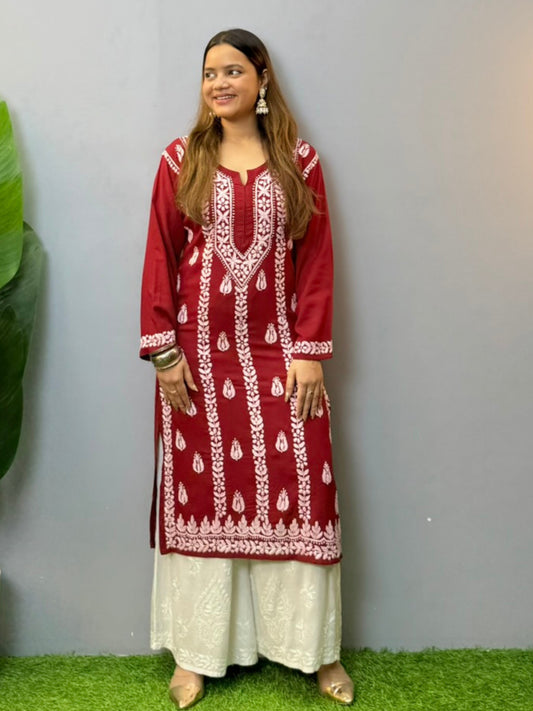 Woman wearing maroon rayon chikankari kurta with white hand embroidery, styled with white palazzo