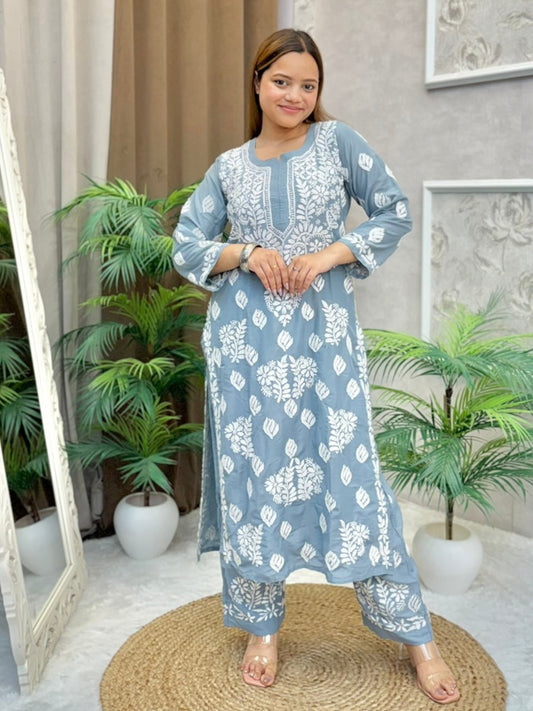Model wearing a grey muslin Lucknowi chikankari kurta and pant set with white floral embroidery, styled for an elegant ethnic look.