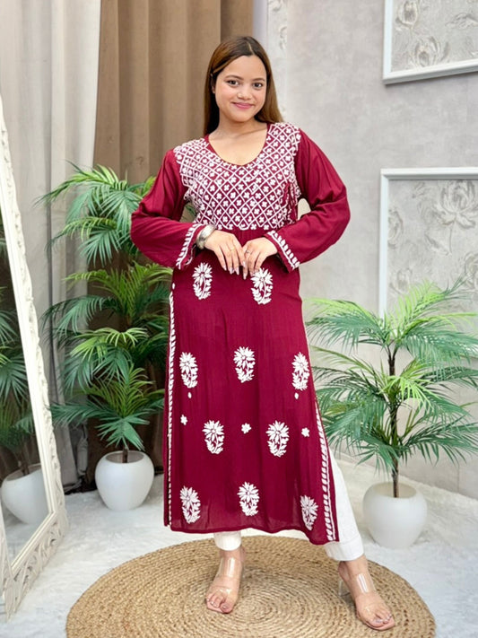 Model wearing a maroon Lucknowi chikankari angrakha-style kurta with white floral embroidery, in premium modal fabric.