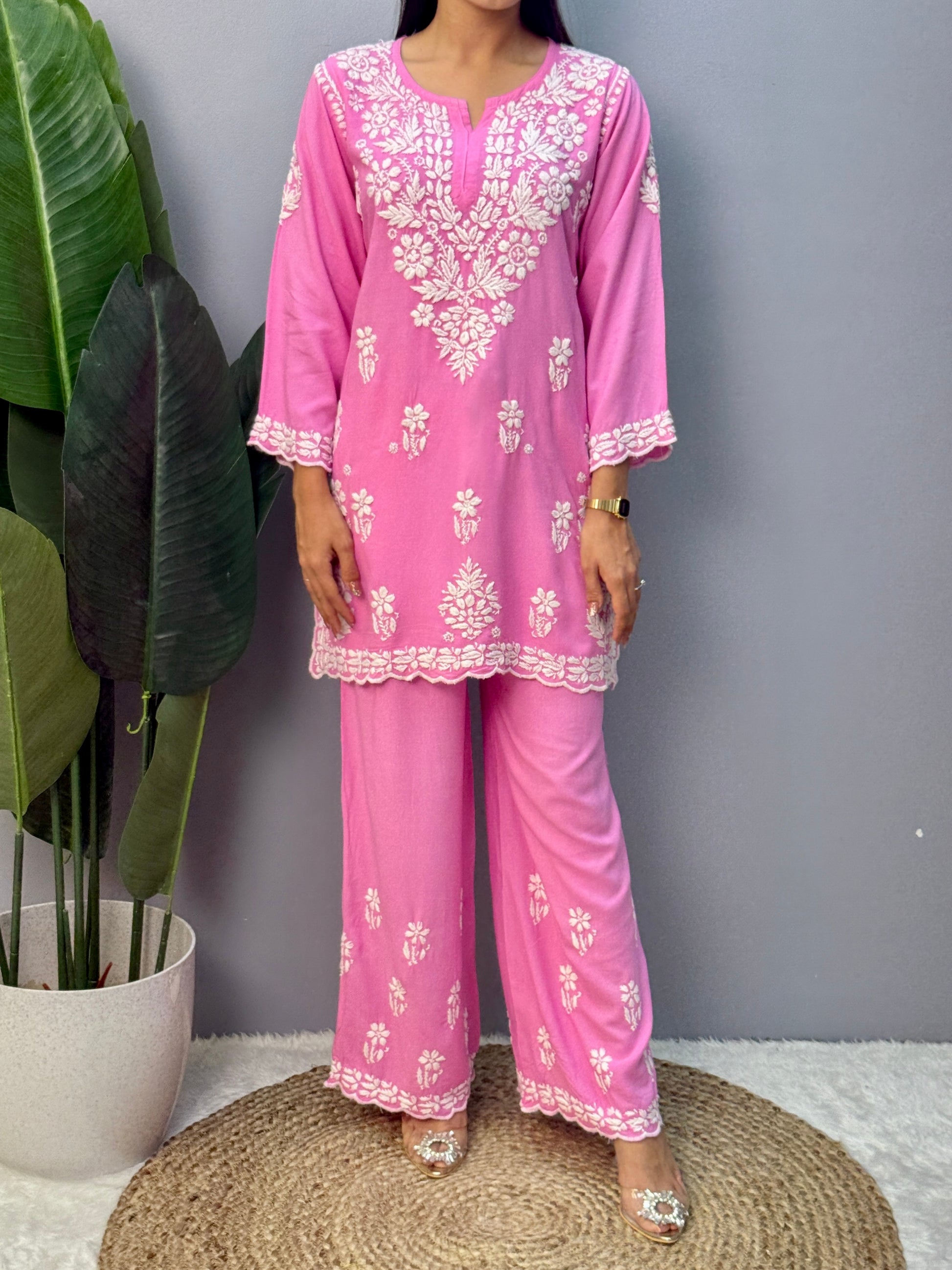 Pink rayon short kurta with palazzo pant featuring white hand-embroidered Lucknow Chikankari design.