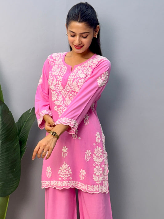 Pink rayon short kurta with palazzo pant featuring white hand-embroidered Lucknow Chikankari design.