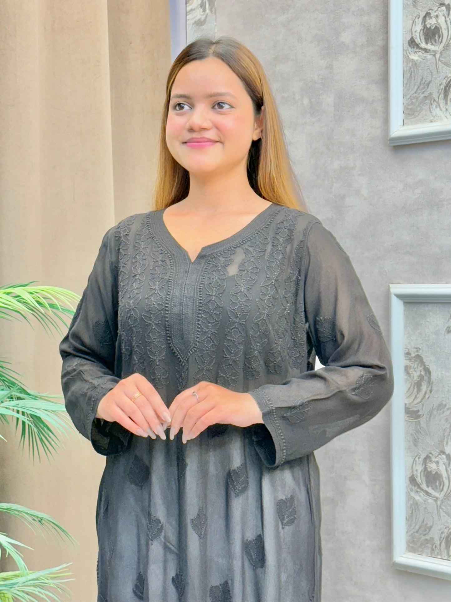 Woman wearing charcoal black chikankari kurta with tonal embroidery and V-neck design