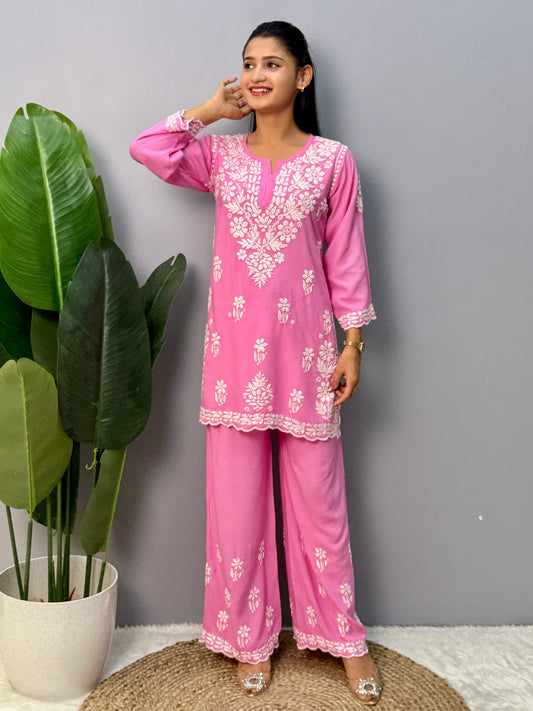 Pink rayon short kurta with palazzo pant featuring white hand-embroidered Lucknow Chikankari design.