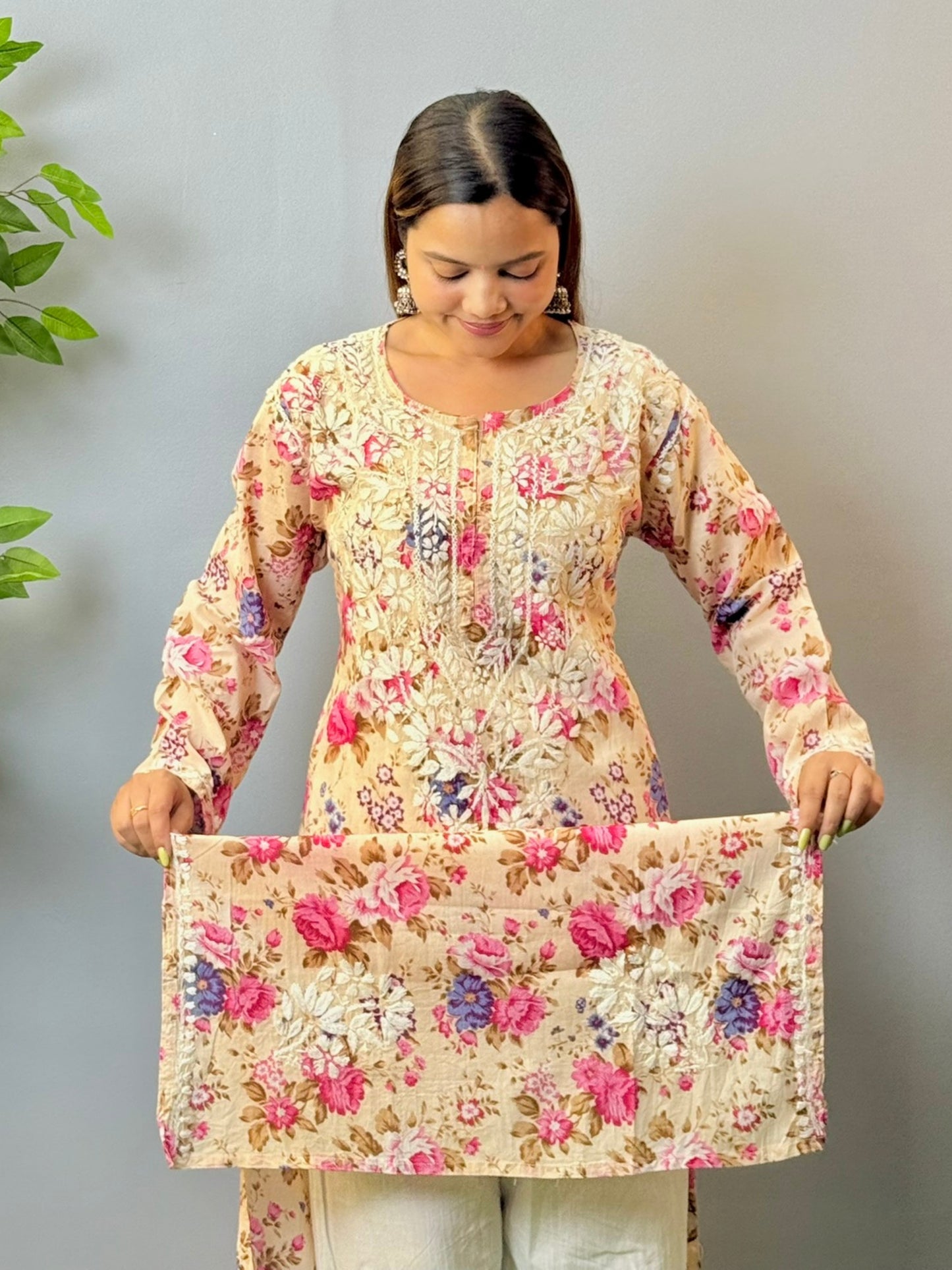 Woman in beige floral printed mulmul cotton chikankari kurta with white embroidery