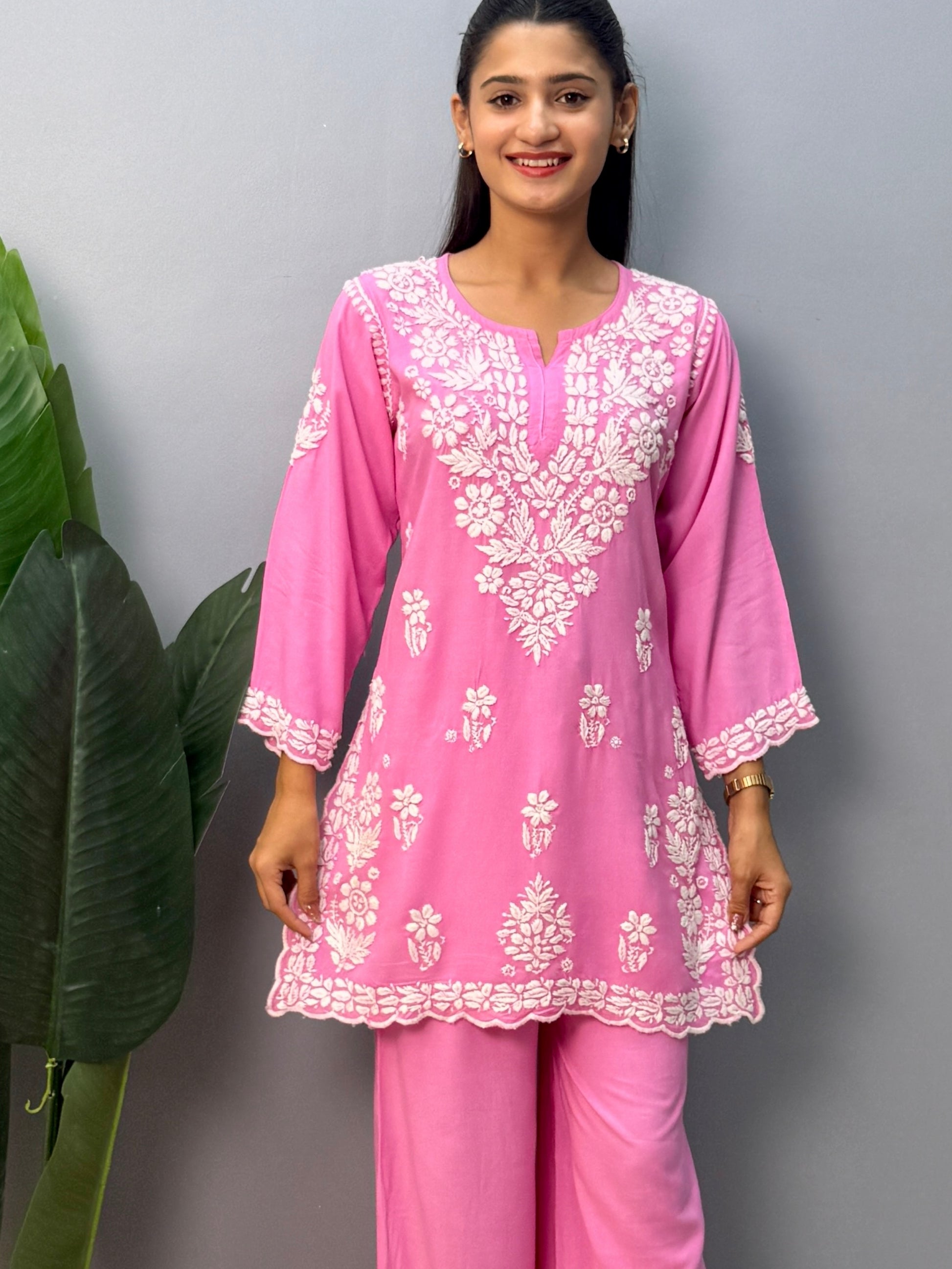 Pink rayon short kurta with palazzo pant featuring white hand-embroidered Lucknow Chikankari design.
