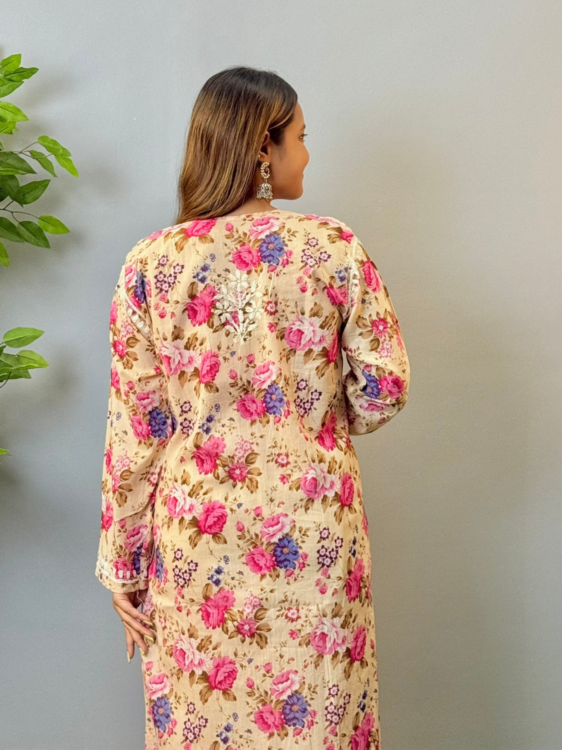 Woman in beige floral printed mulmul cotton chikankari kurta with white embroidery