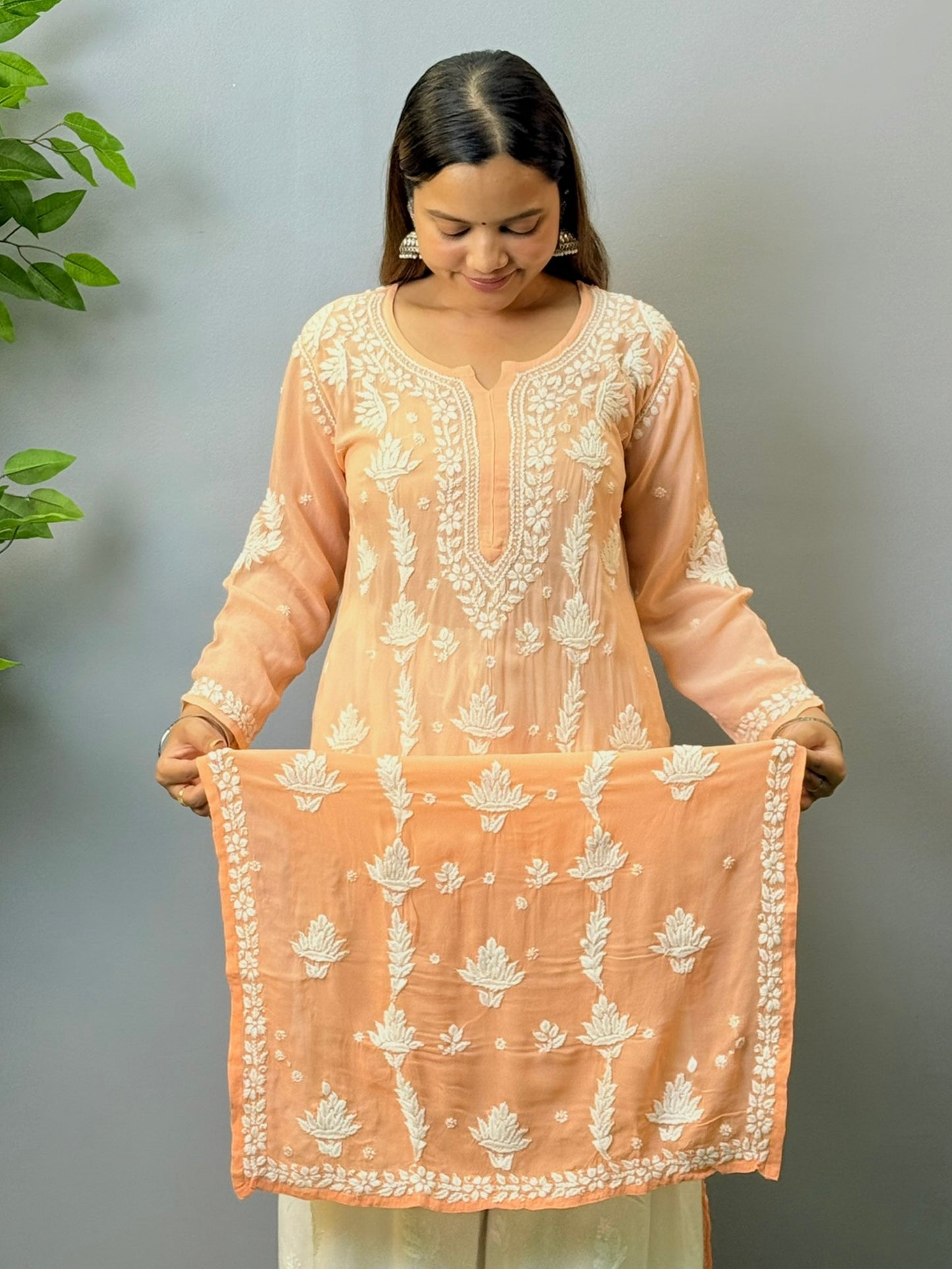 Woman wearing peach ombré viscose Chikankari kurta with white embroidery