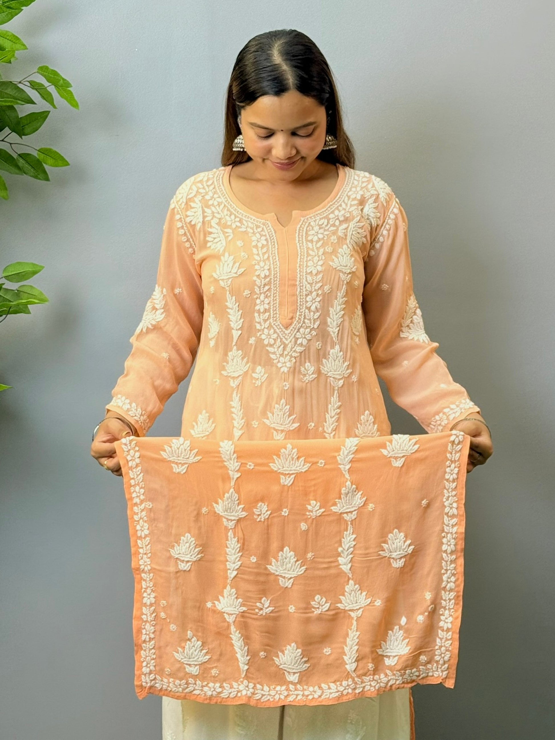 Woman wearing peach ombré viscose Chikankari kurta with white embroidery